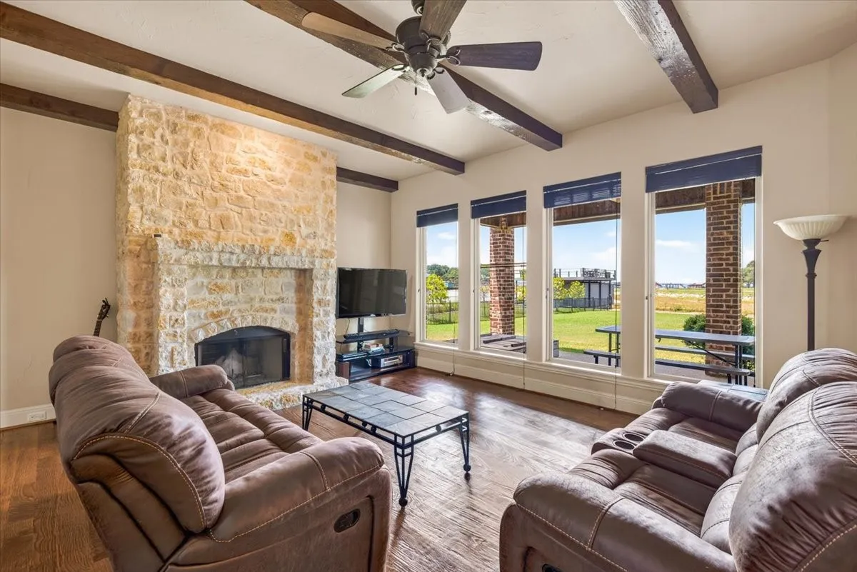 Austin stone fireplace and large picture windows in main living area.