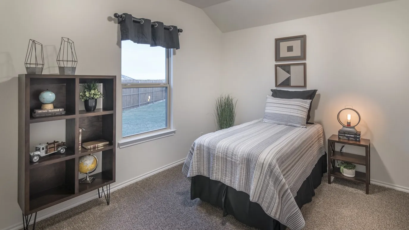 Neutral-toned room featuring a single window with a valance, soft carpet flooring, and light-colored walls