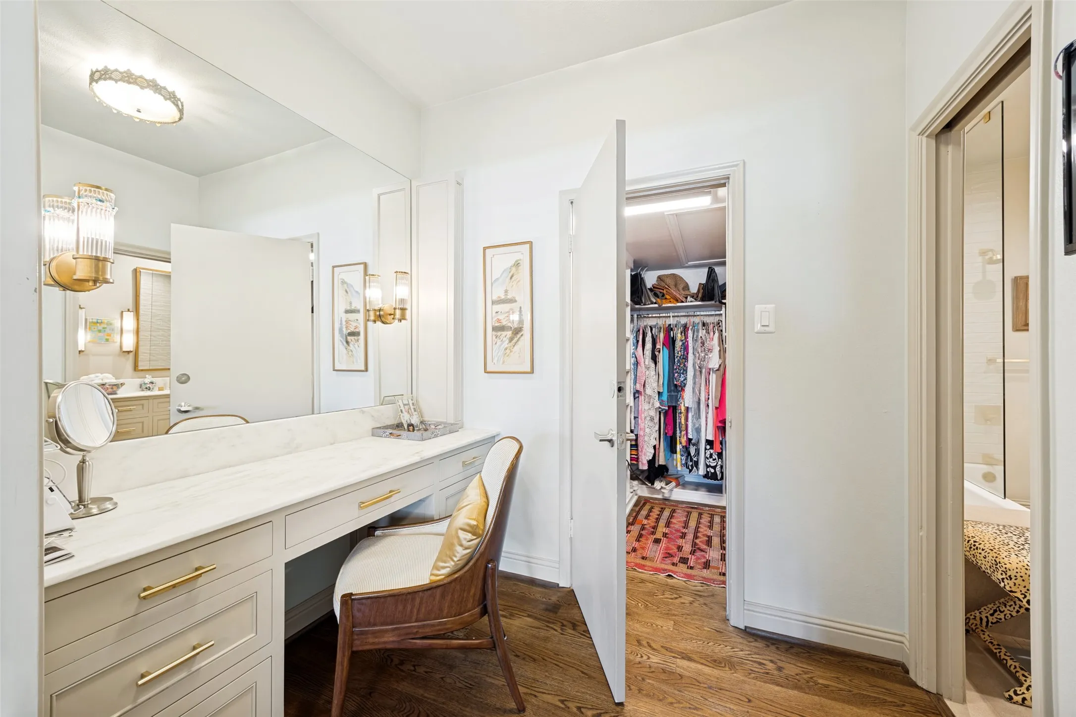 Vanity area with marble counter top. Walk into custom closet