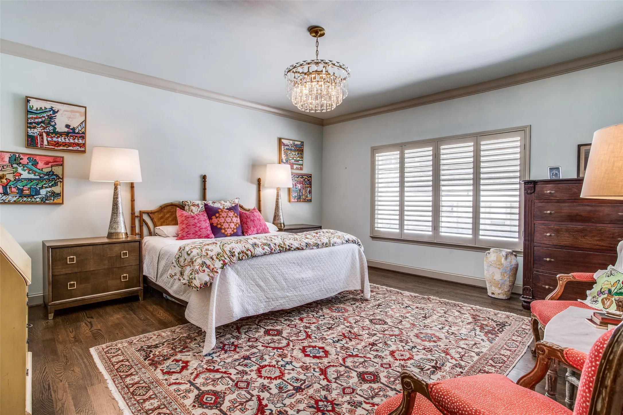 Primary bedroom with Designer chandelier and plantation shutters