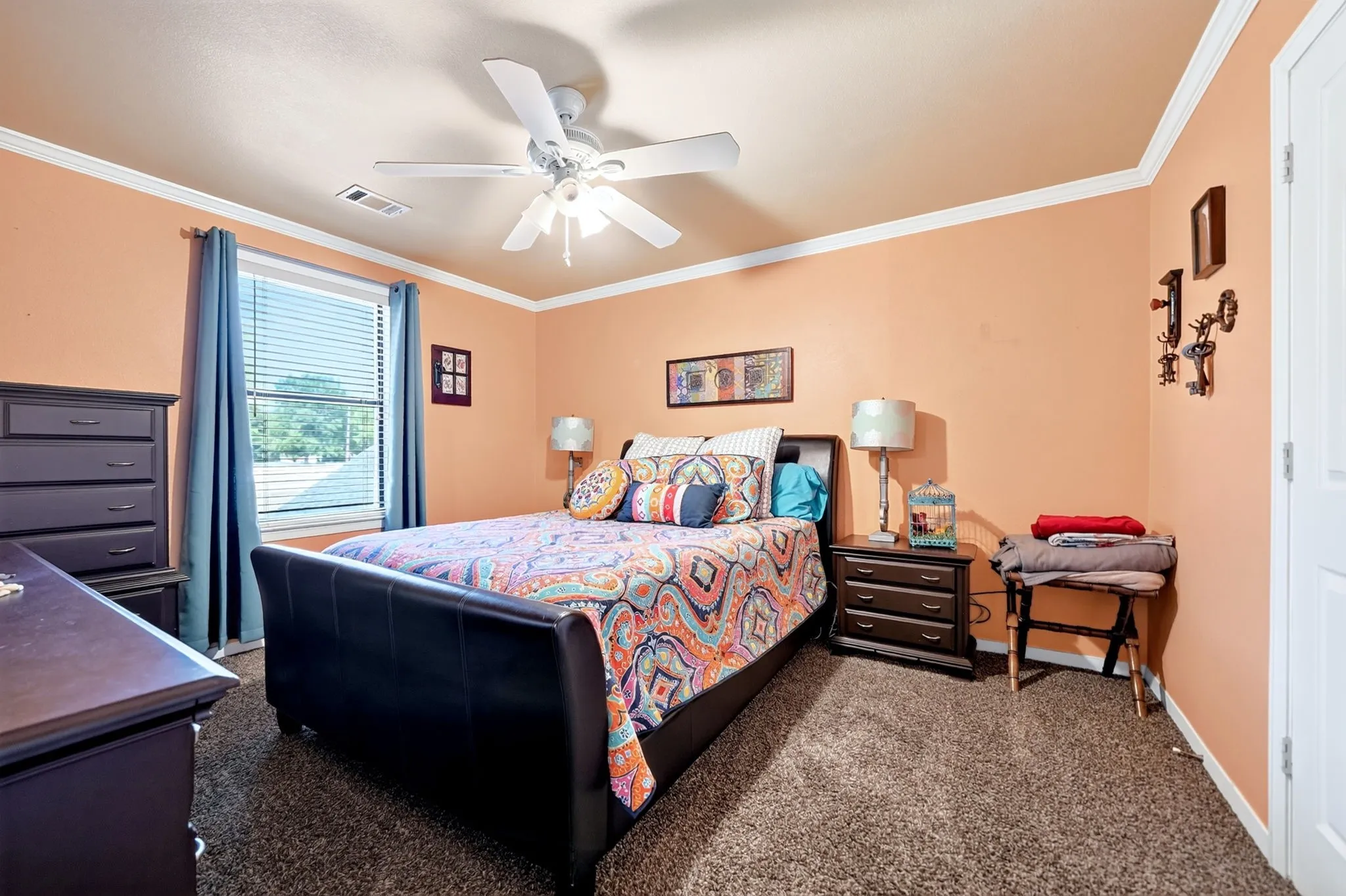 Bedroom featuring a single window, white crown molding, and textured carpet flooring