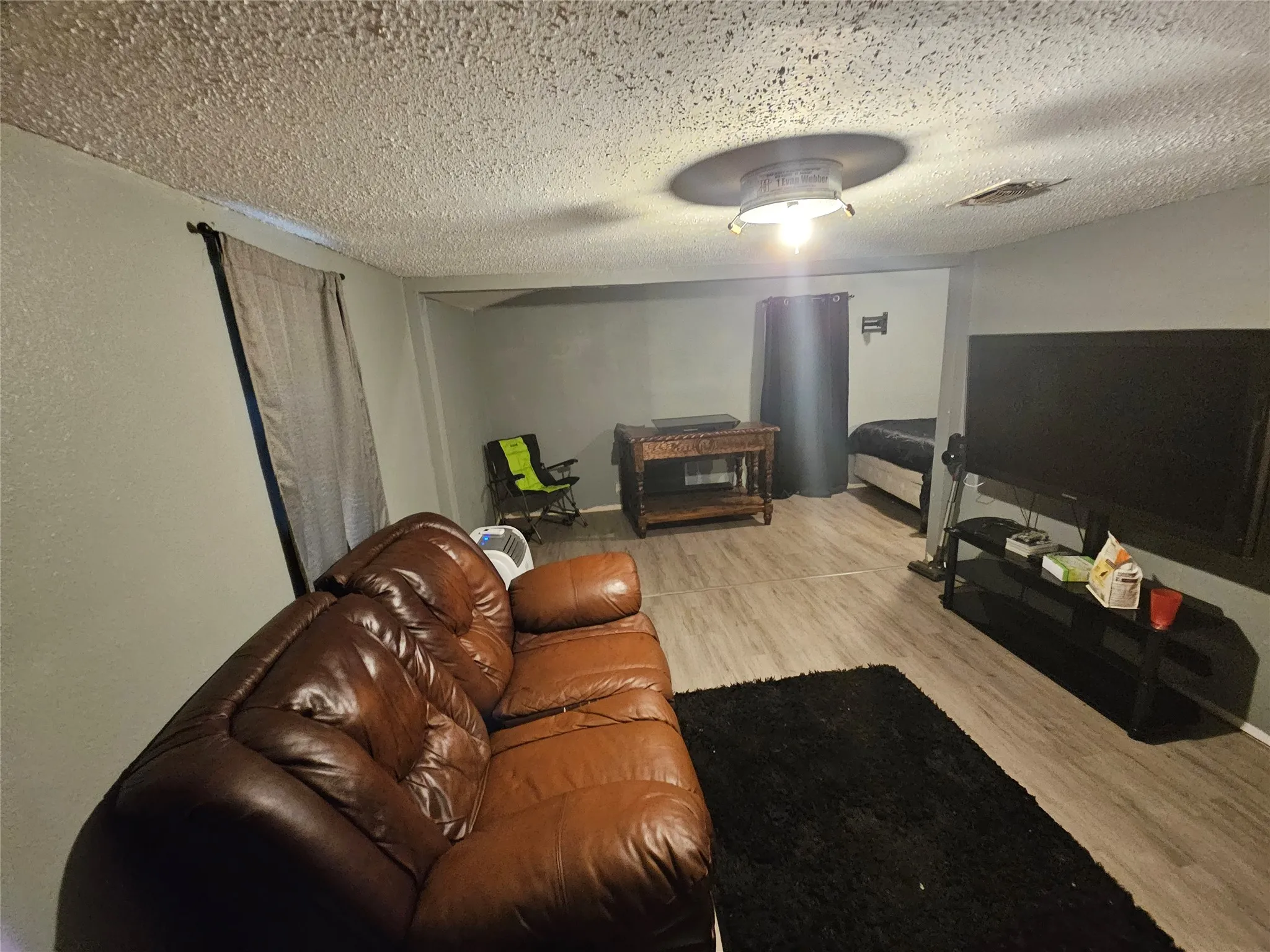 Interior space featuring grey walls and wood-finish flooring