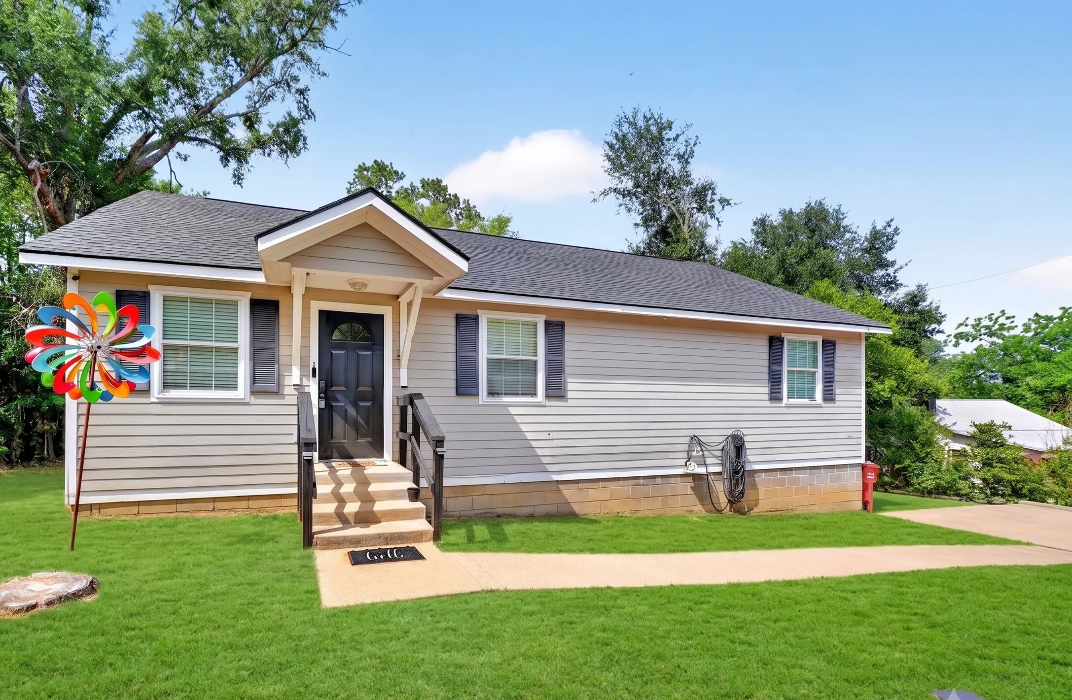 Light-toned siding exterior with dark shutters