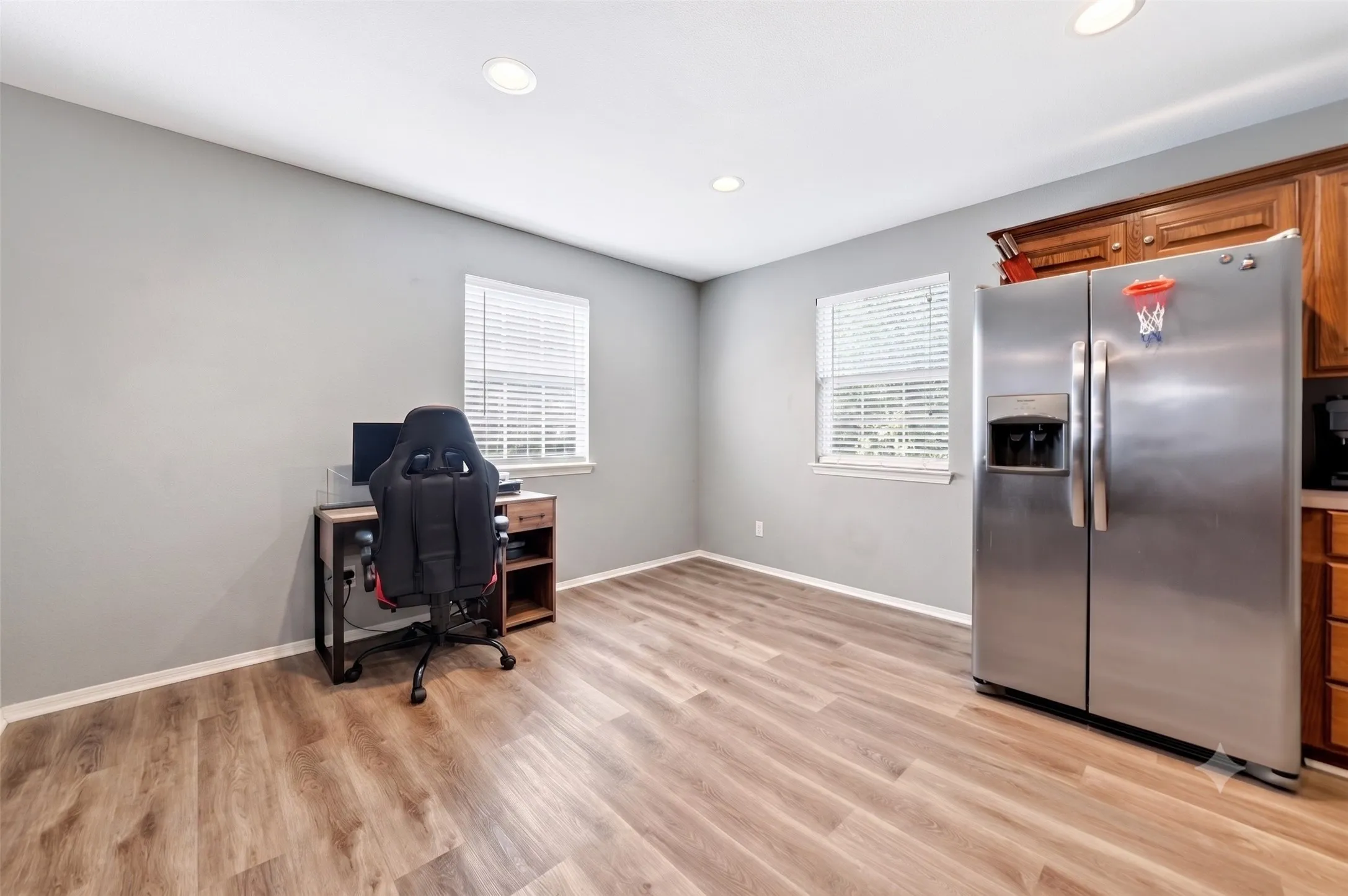 Light wood-finish flooring complements the neutral wall color