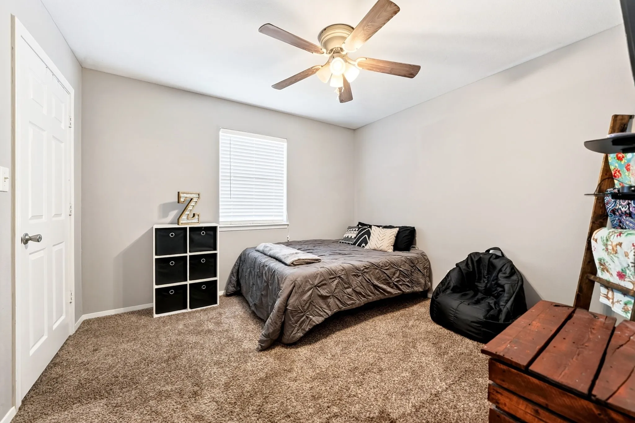 Neutral-toned bedroom featuring plush brown carpeting and light gray walls