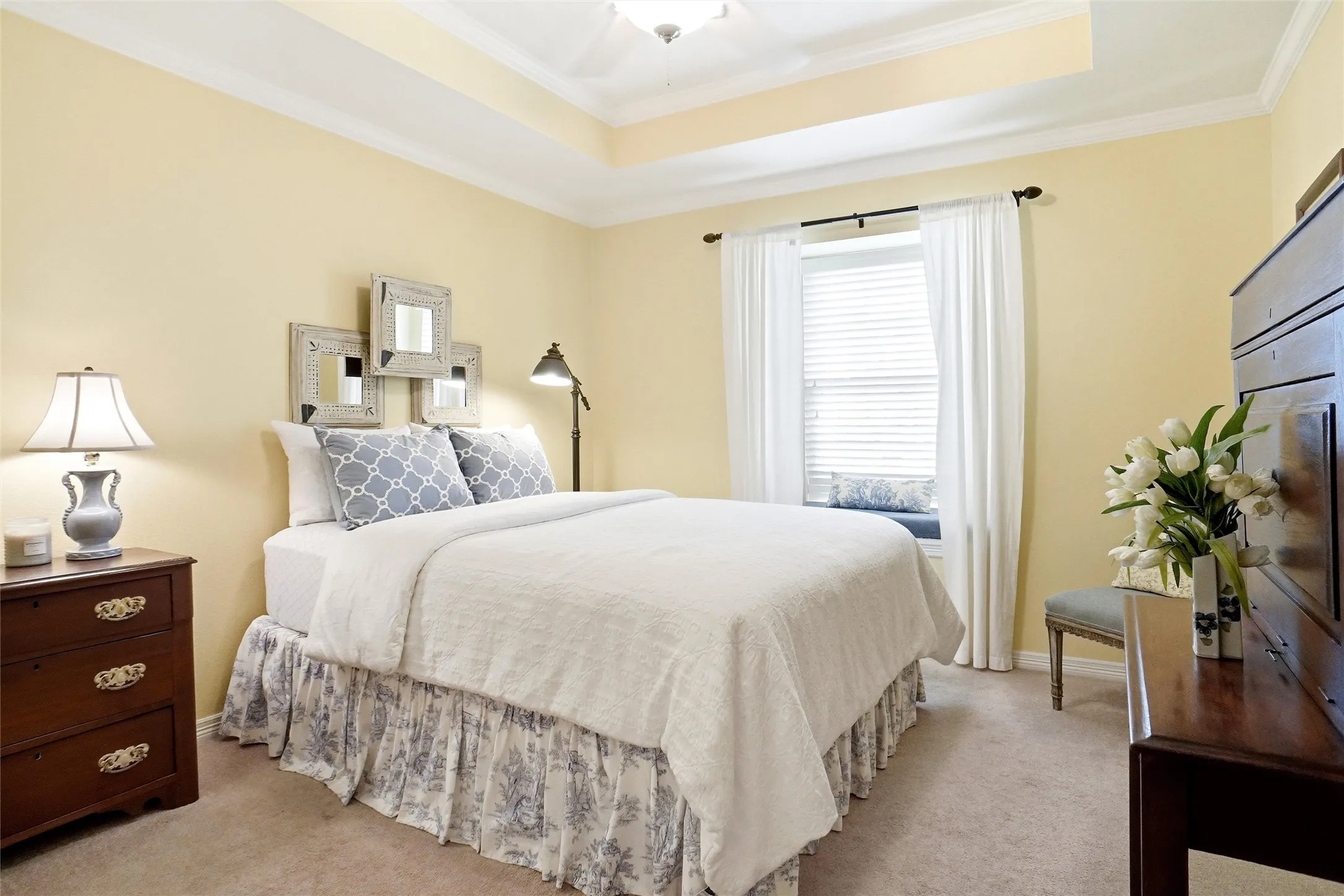 Raised box ceiling, windo seat and crown molding.