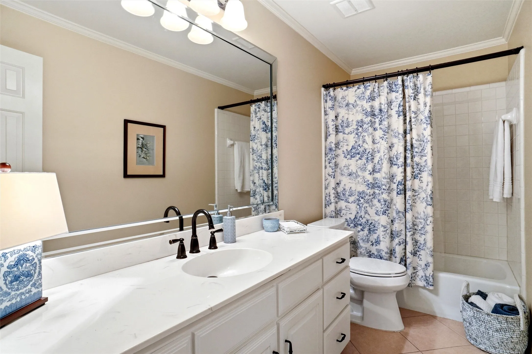 Large single sink vanity and tiled bath/shower combo.