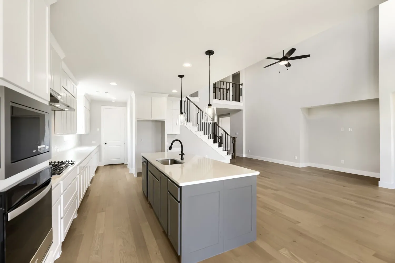 Kitchen featuring a center island with a sink, stainless steel appliances, and white cabinetry