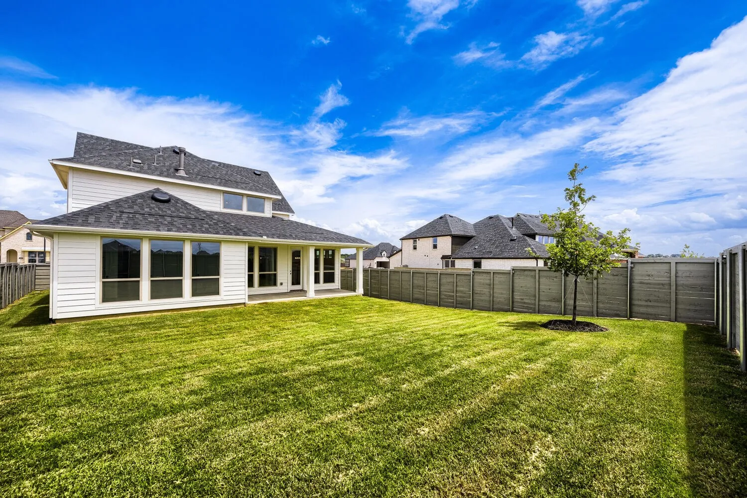 Expansive grass lawn with a perimeter fence