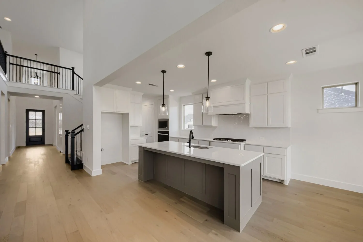 Open-concept living space with light wood-finish flooring