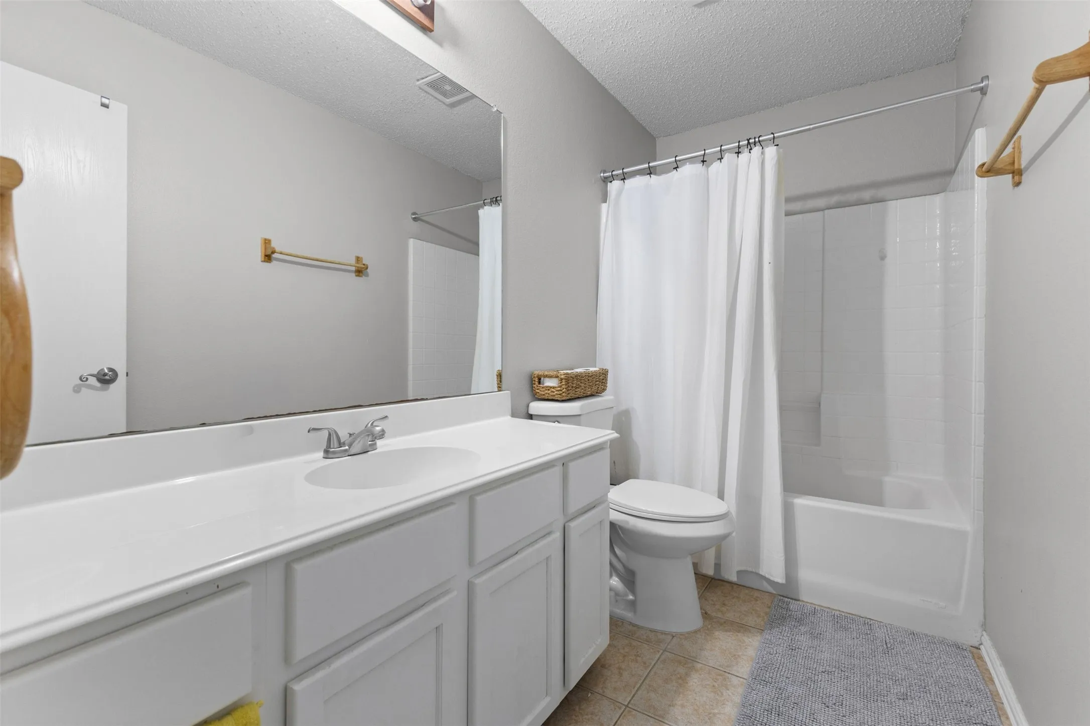 Bathroom with a white vanity featuring a single basin sink and chrome faucet