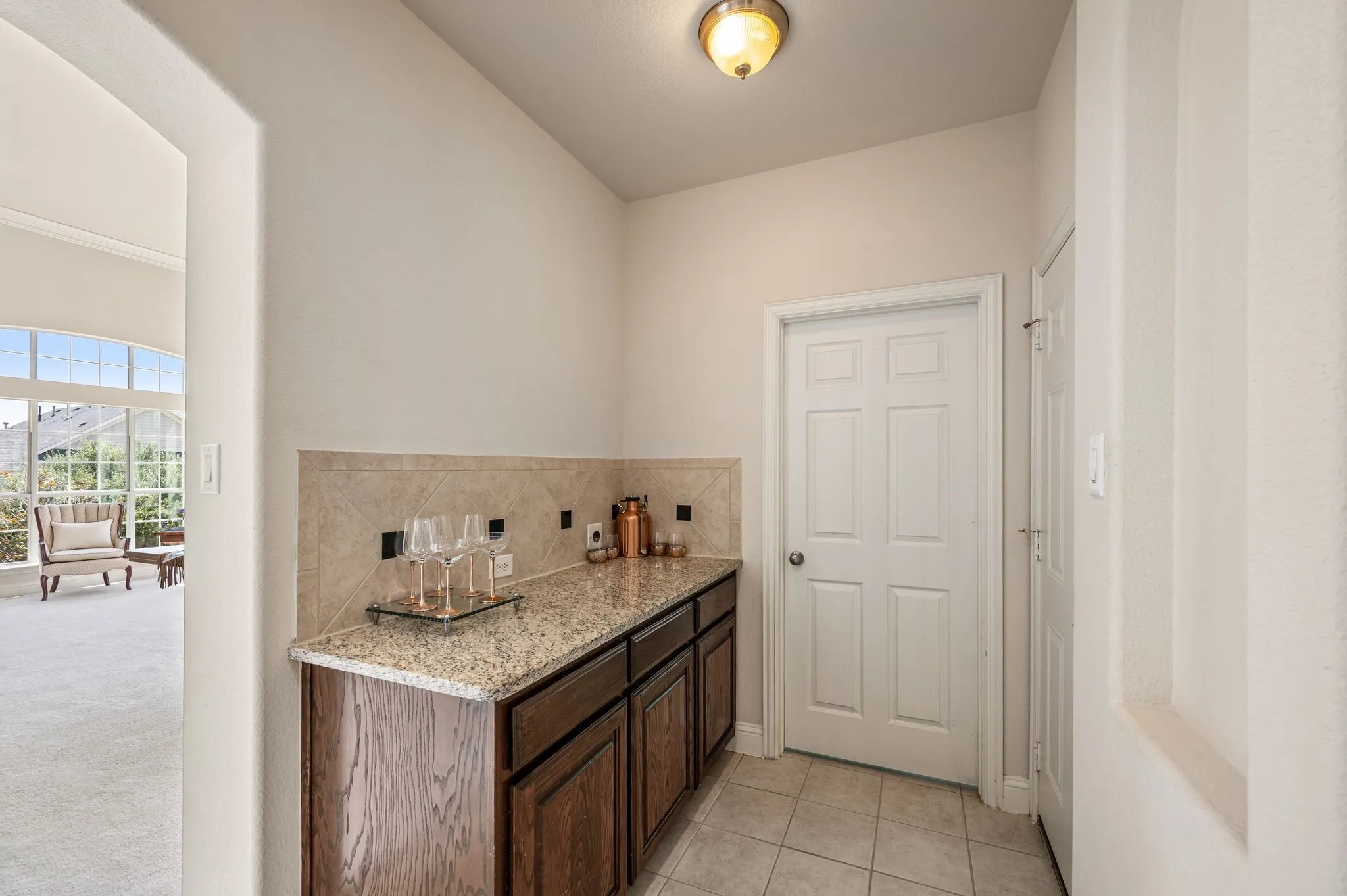 This convenient butler's serving area provides additional storage, prep space & organization.  It sits right outside the laundry room, so this space could be enclosed to triple your laundry room space, or to make a huge walk-in pantry!