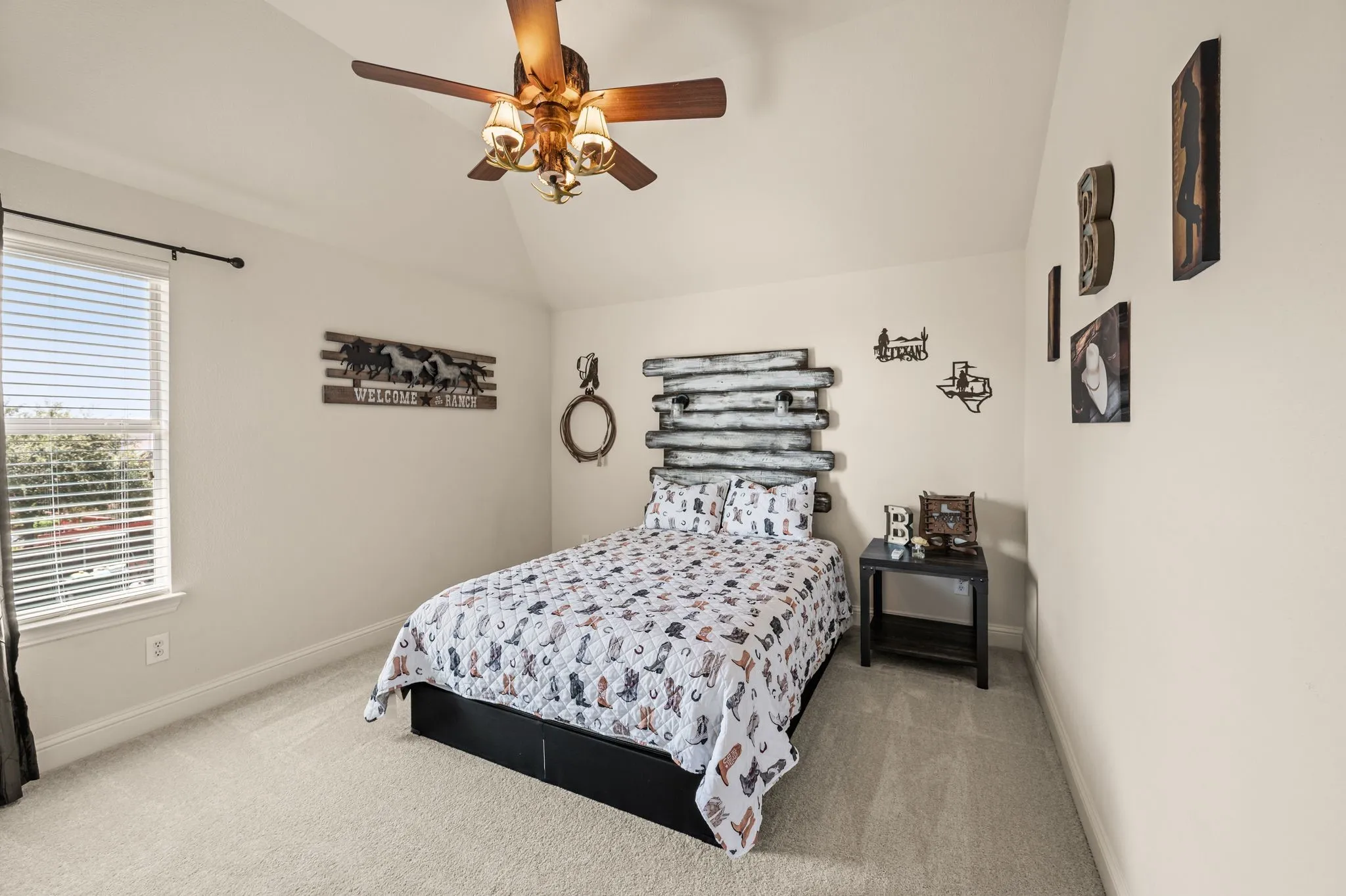 Inviting upstairs secondary bedroom with vaulted ceilings & plenty of room for family or guests.