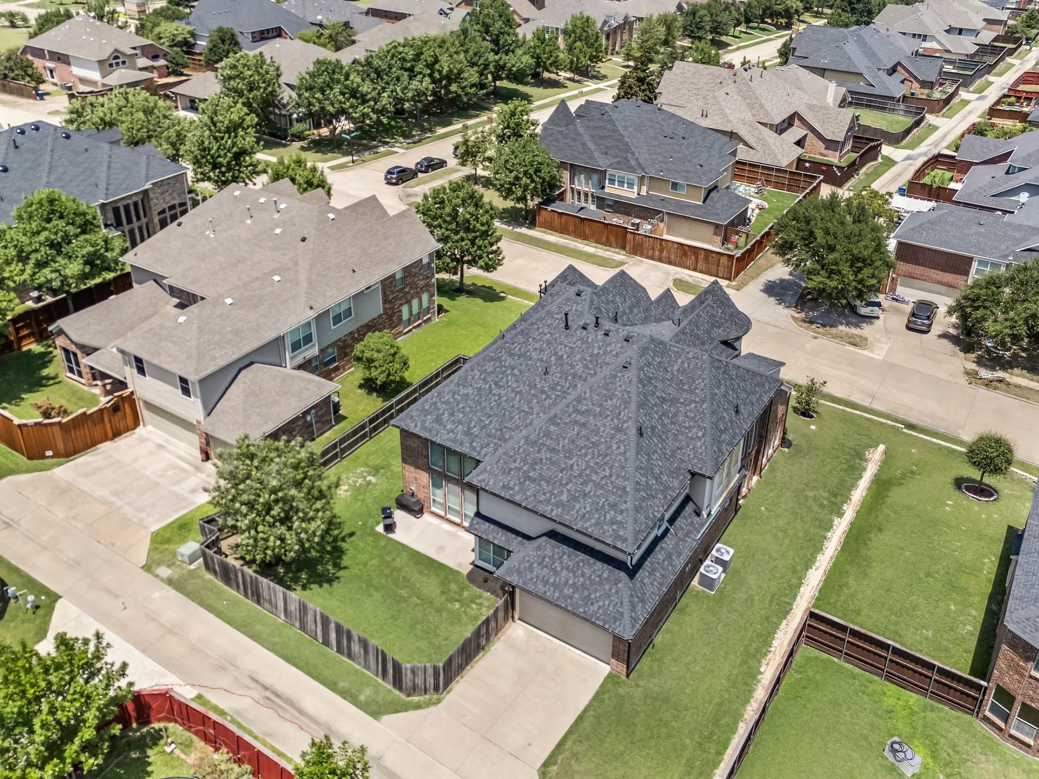 Aerial view showcasing the home's impressive size, generous lot & beautiful neighborhood setting.