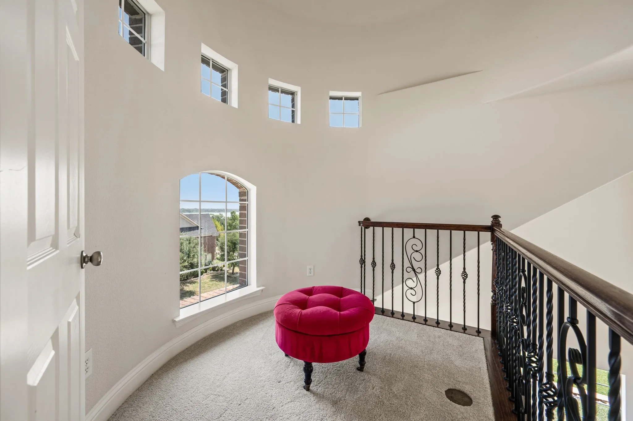 Charming upstairs landing filled with natural light from a wall of oversized windows.