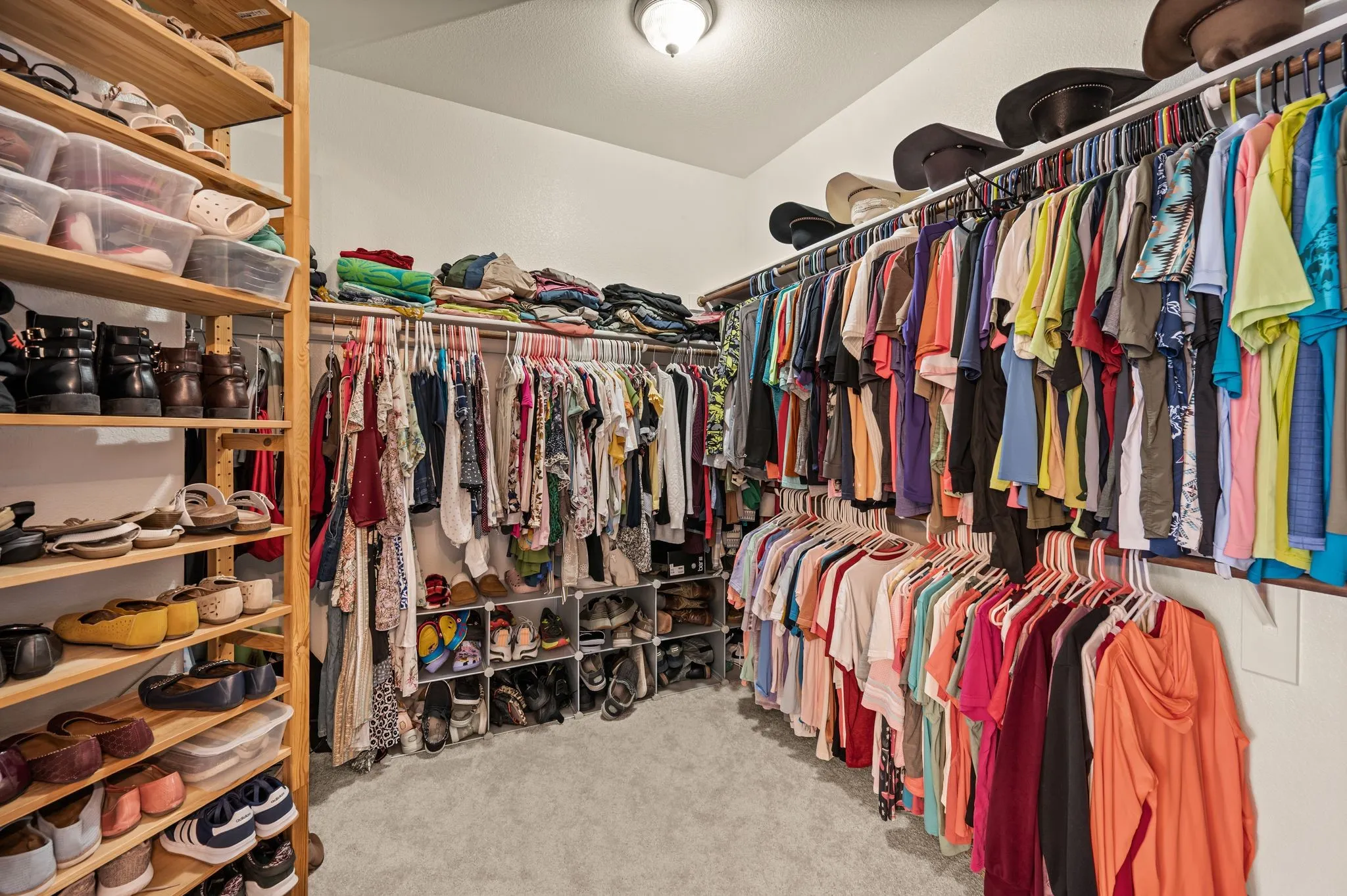 Enormous walk-in primary closet with abundant hanging space, shelving & storage for every season.