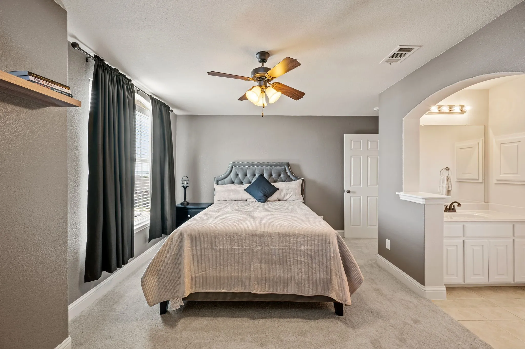 Spacious upstairs secondary bedroom with private vanity area, creating comfort & convenience.