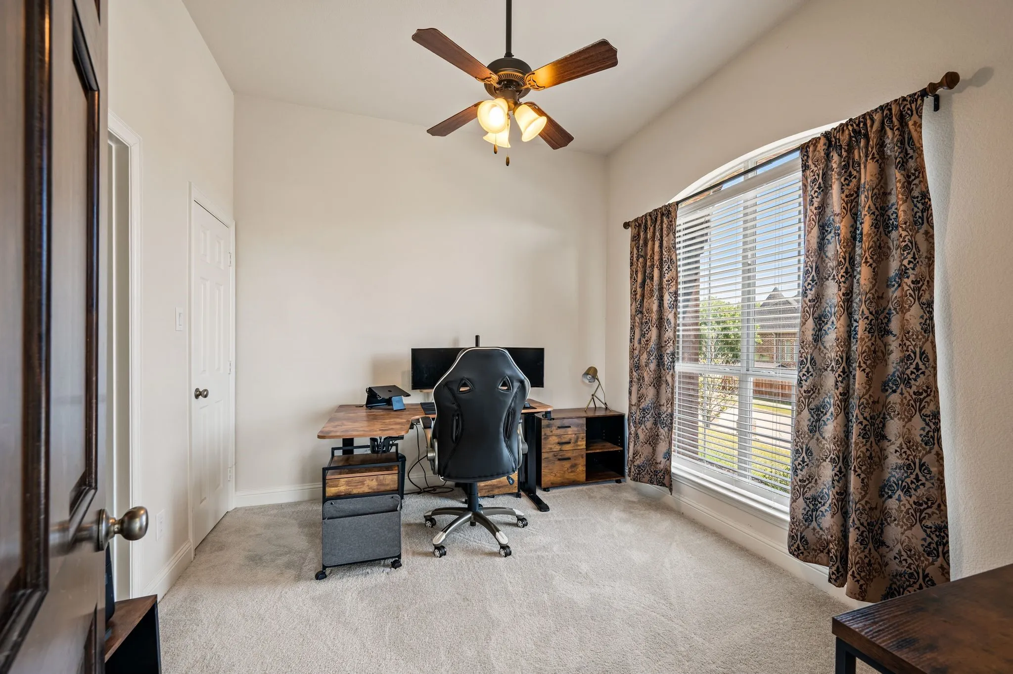 This is the downstairs secondary bedroom - use as a flex space for guests, a home office, a gym, or multi-generational living.