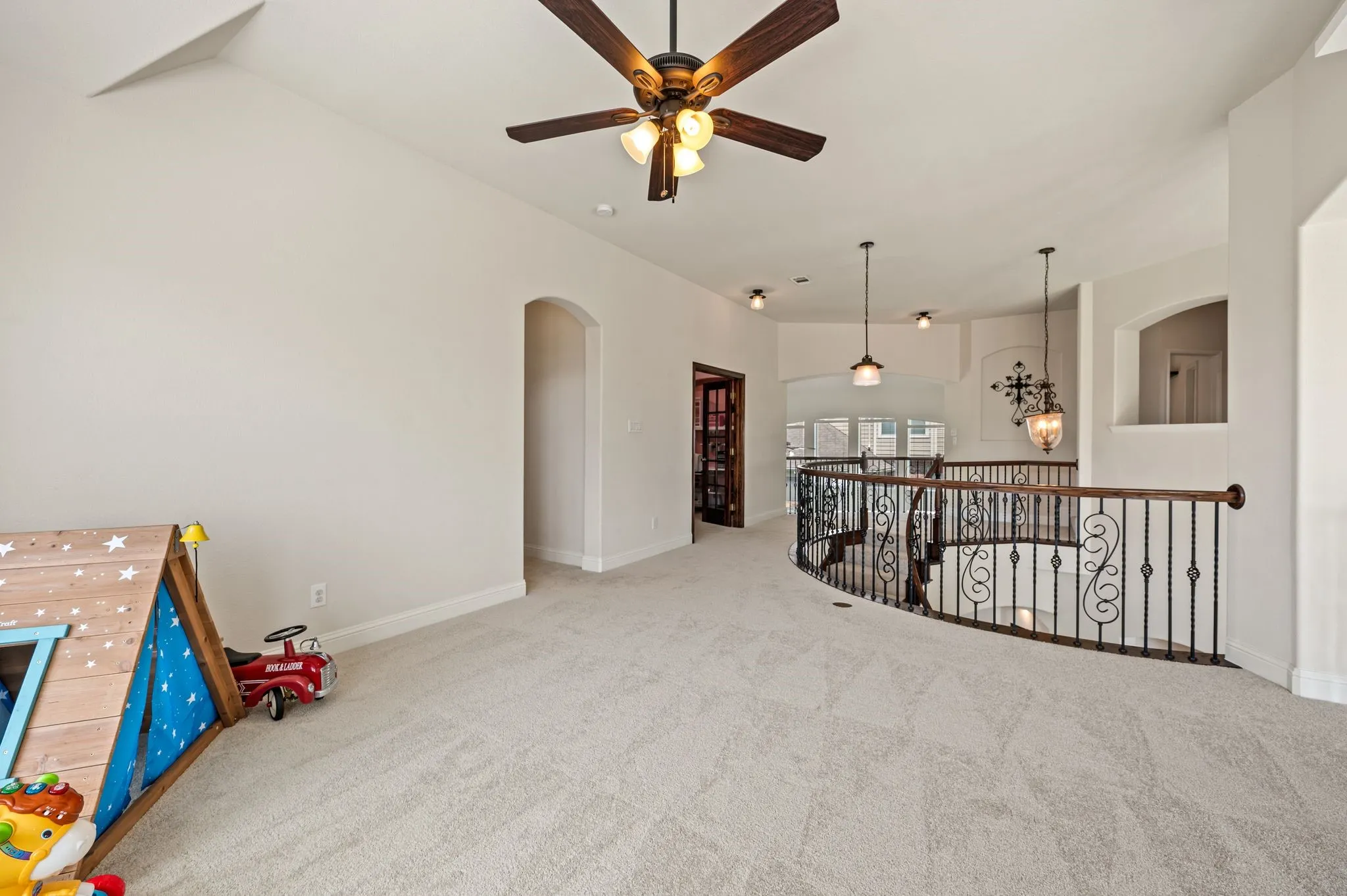 Expansive upstairs game room offering endless possibilities for movie nights, play space or entertaining.  In floor plugs make it easy to arrange your side table lamps!