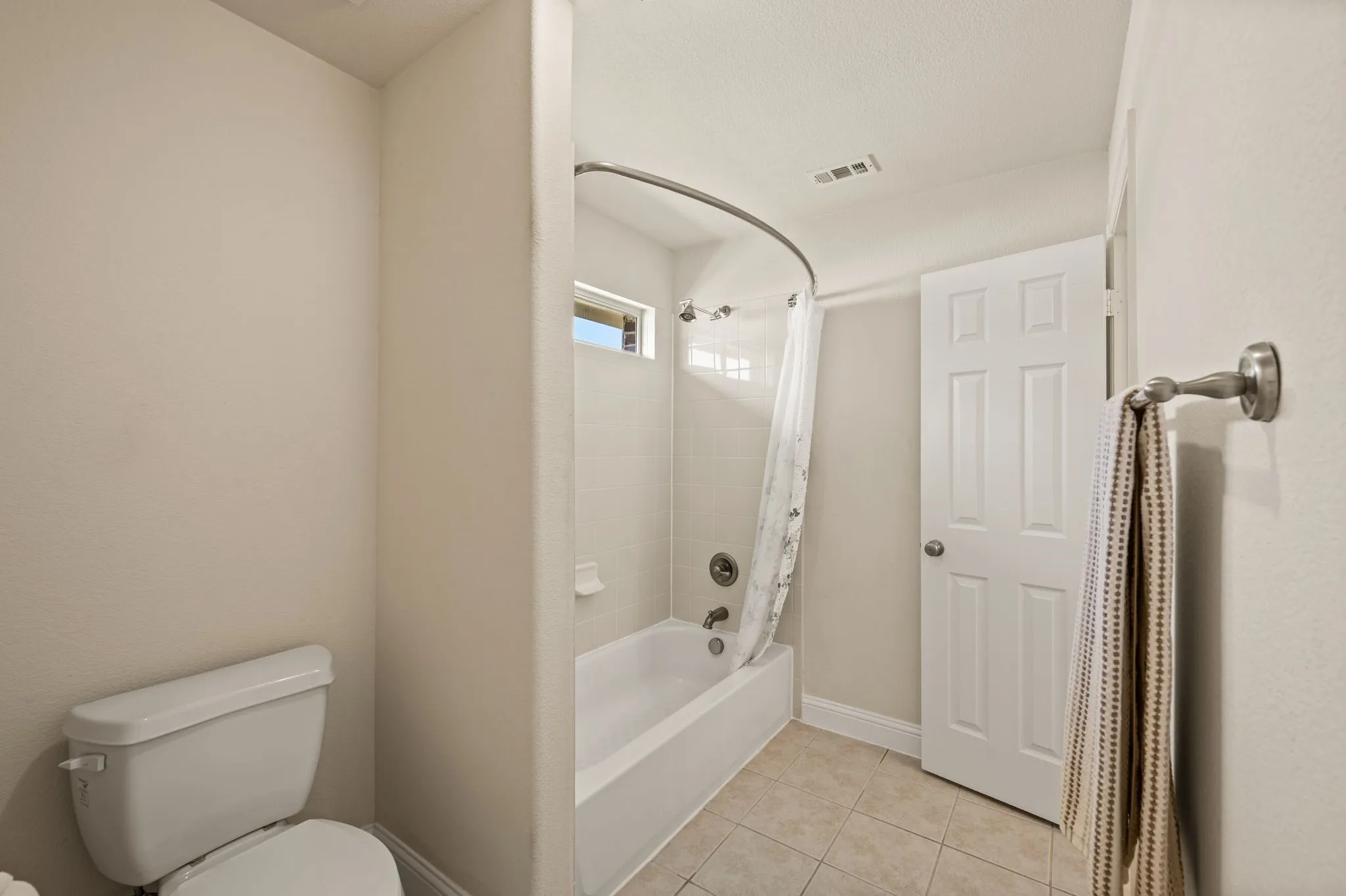 Full upstairs bathroom with tub/shower combination, ideal for family & guests.