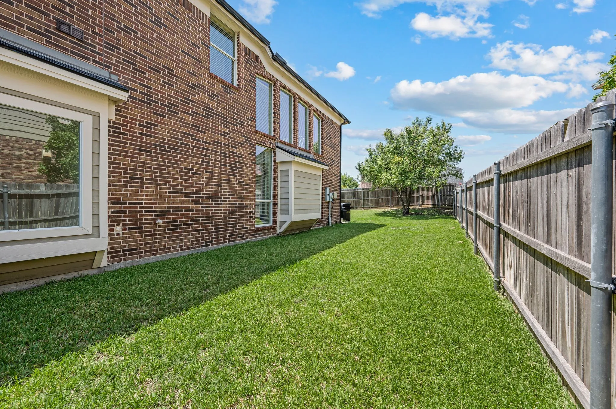 Fully fenced backyard with lush green space perfect for pets, outdoor games & future backyard dreams.