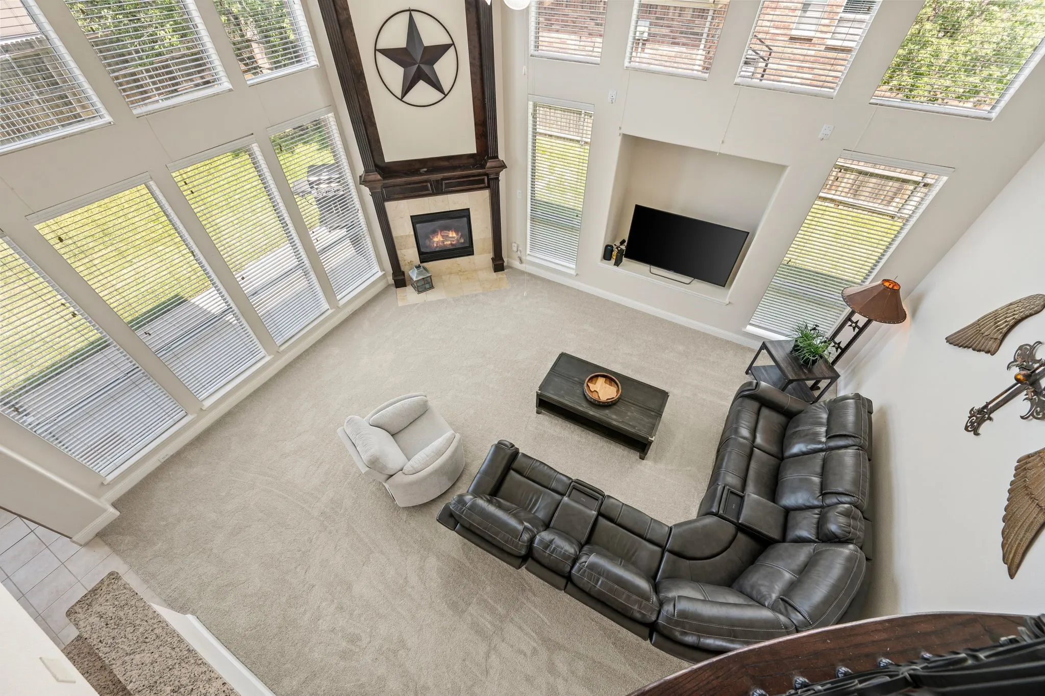 Bird's-eye view showcases the expansive family room with soaring ceilings & an open, airy design.