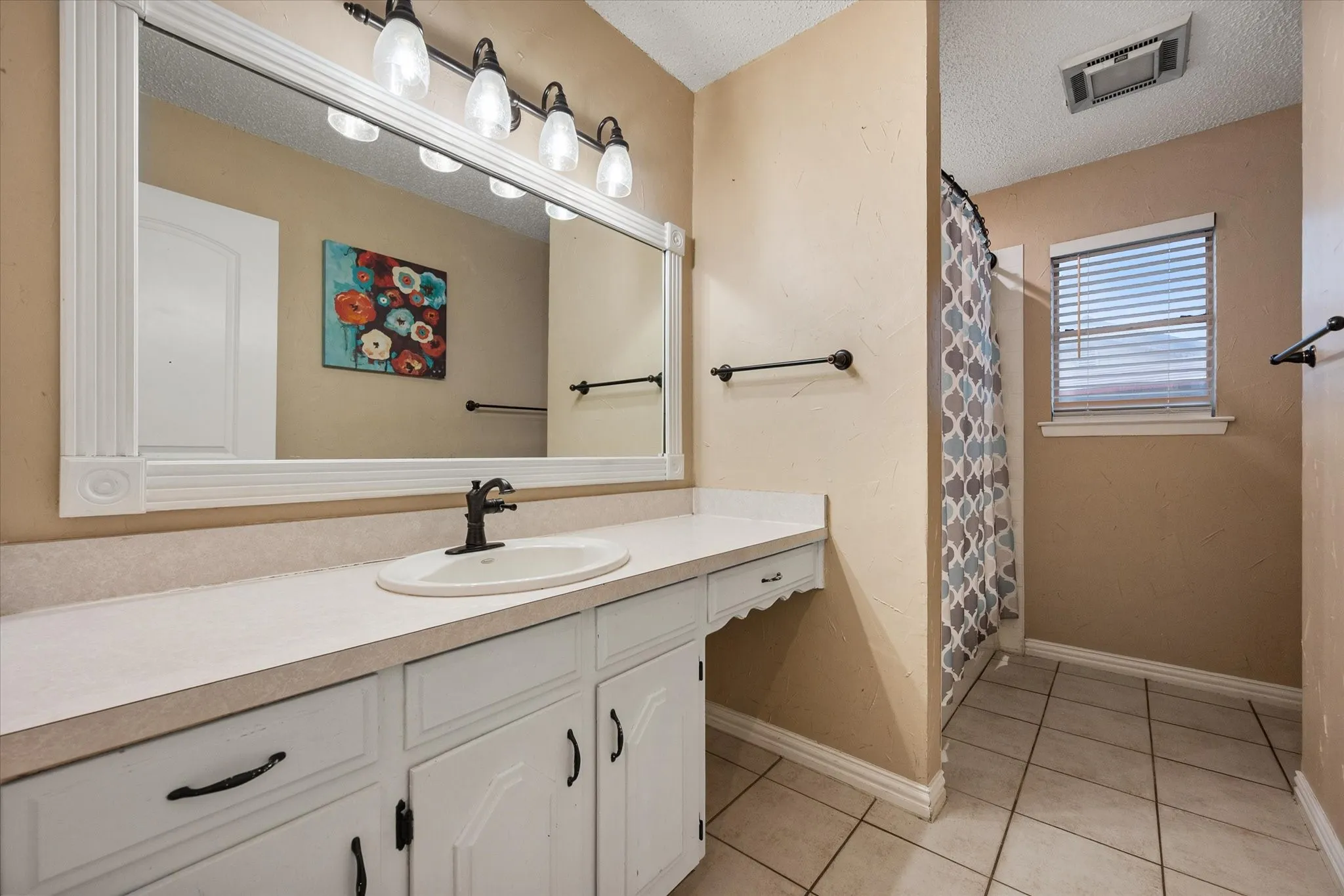 Bathroom #2 has large vanity and tub/shower combo.