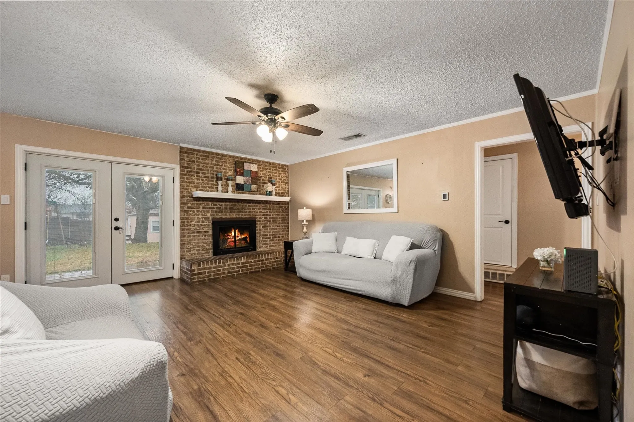 Living room is anchored by a cozy fireplace.