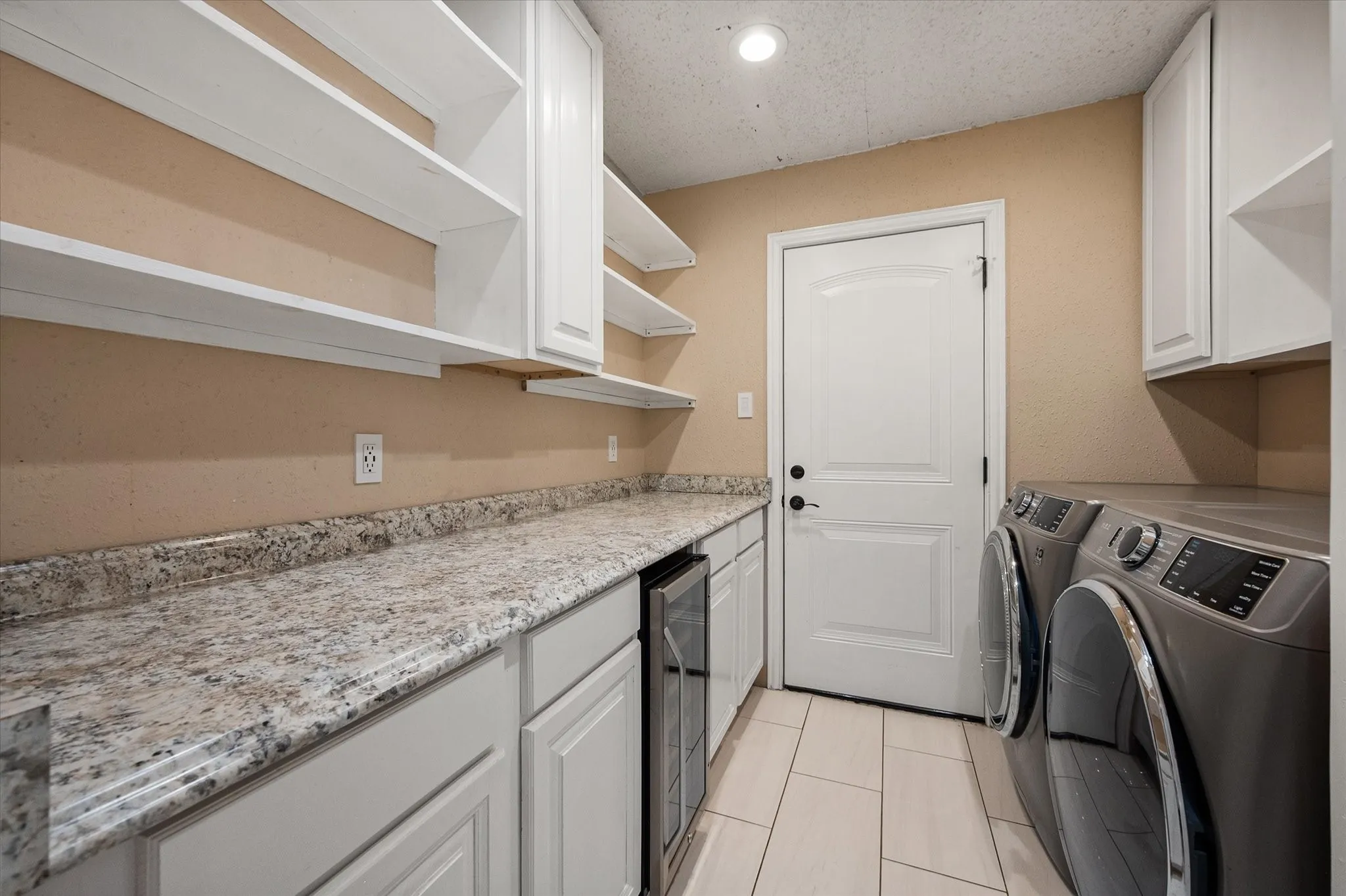 Laundry room has built in shelves and cabinets!