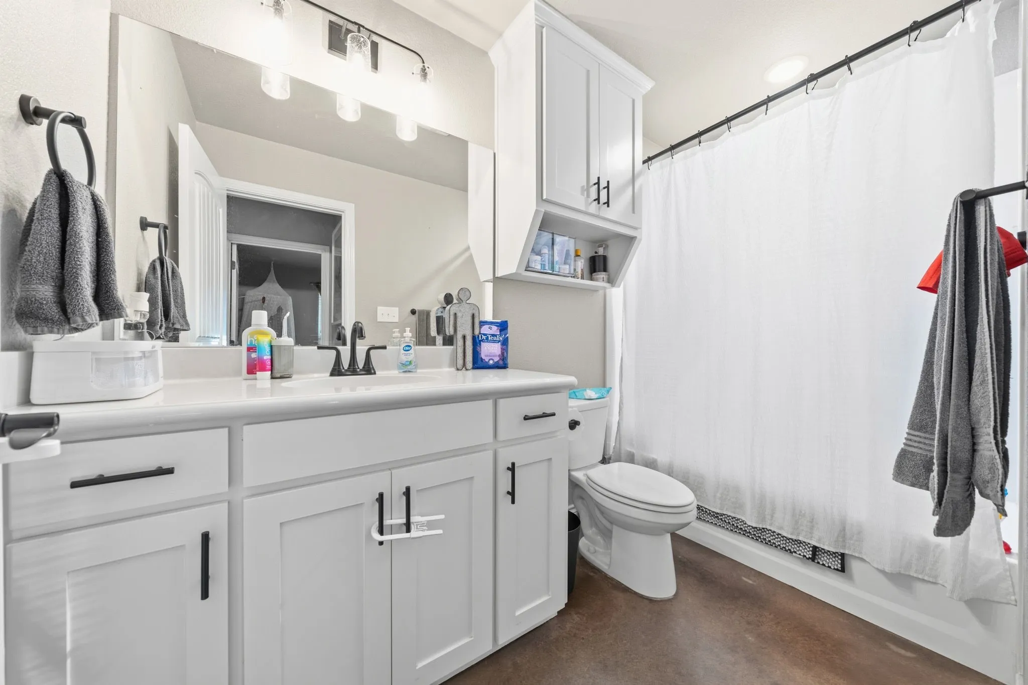Hall bathroom with lots of storage and bathtub shower combo