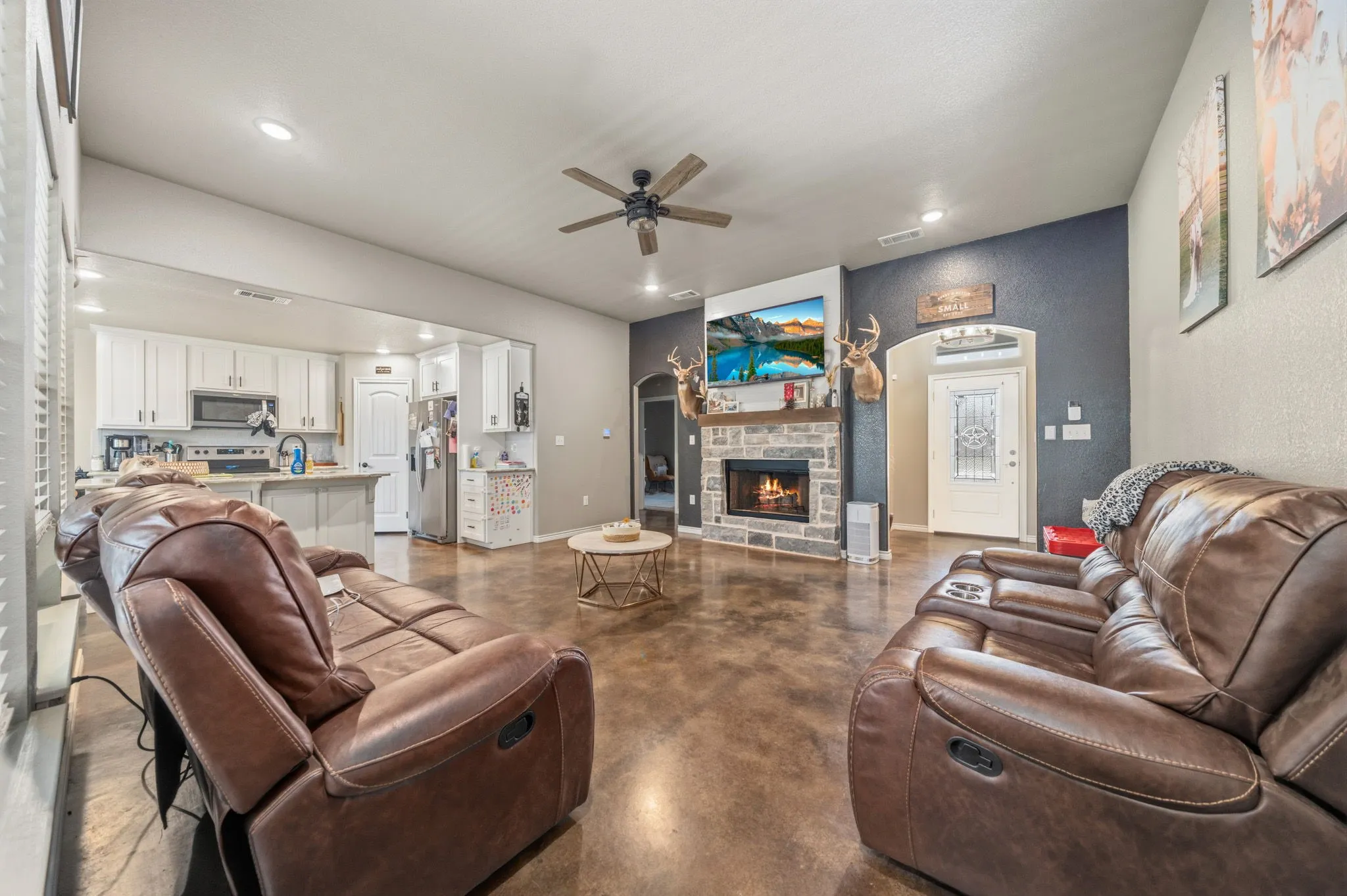 Wood burning fireplace with easy care warm rustic stained concrete floors.