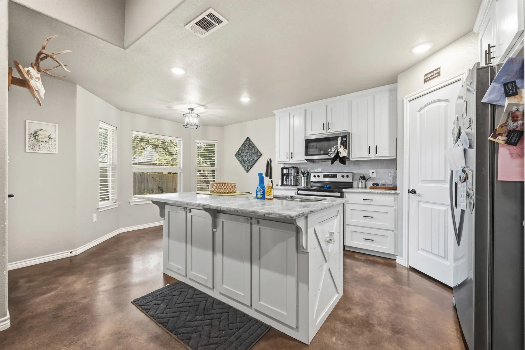 Granite Countertop and stainless built in appliances.  Custom cabinetry and storage pantry.