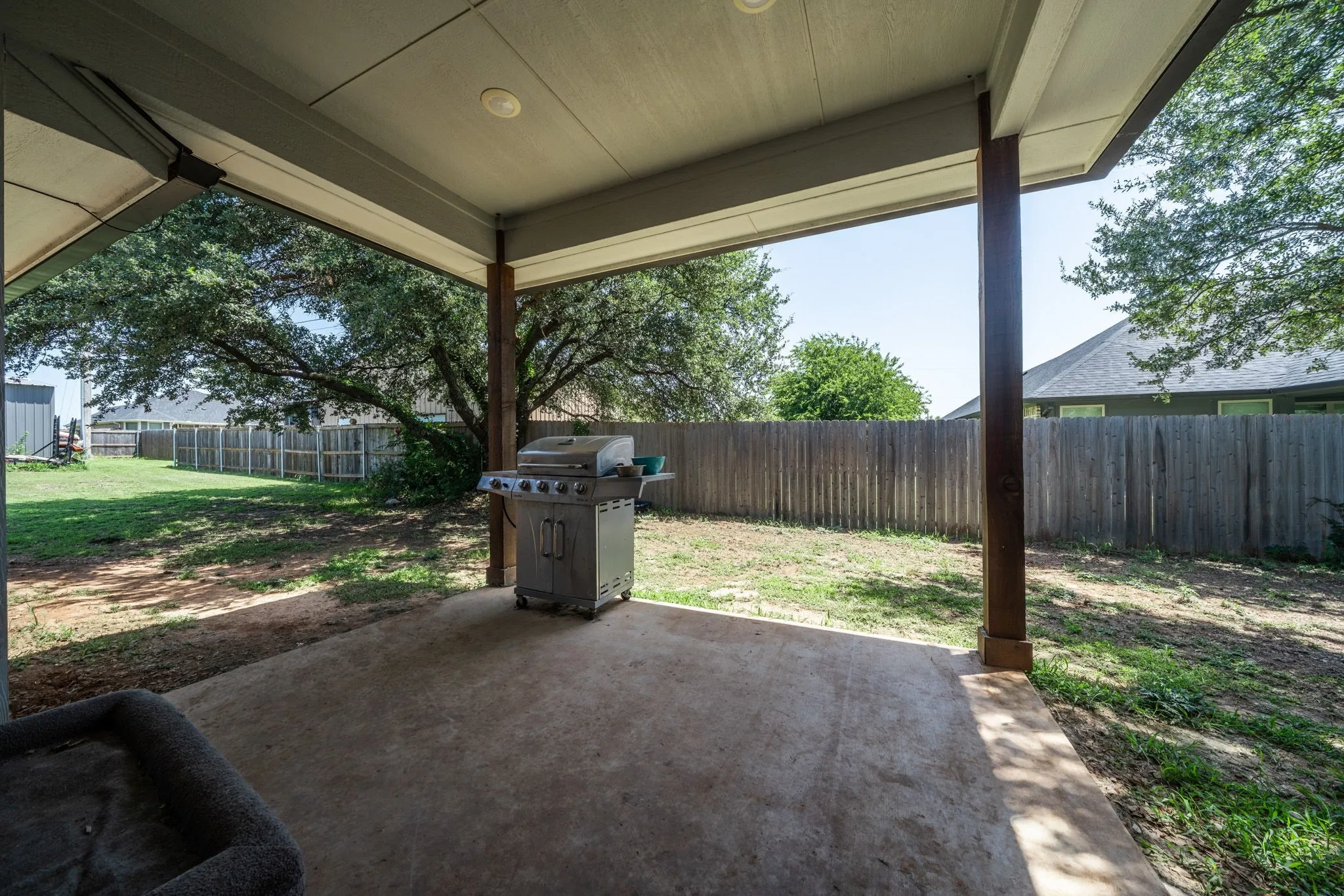 Backyard covered patio and shady backyard.