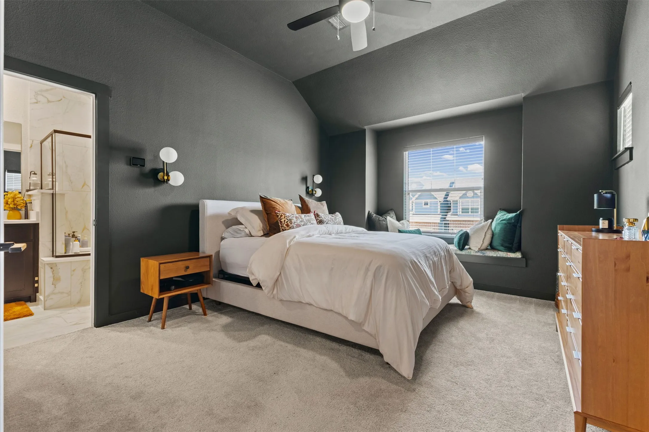 Carpeted room with a recessed window featuring an integrated window seat