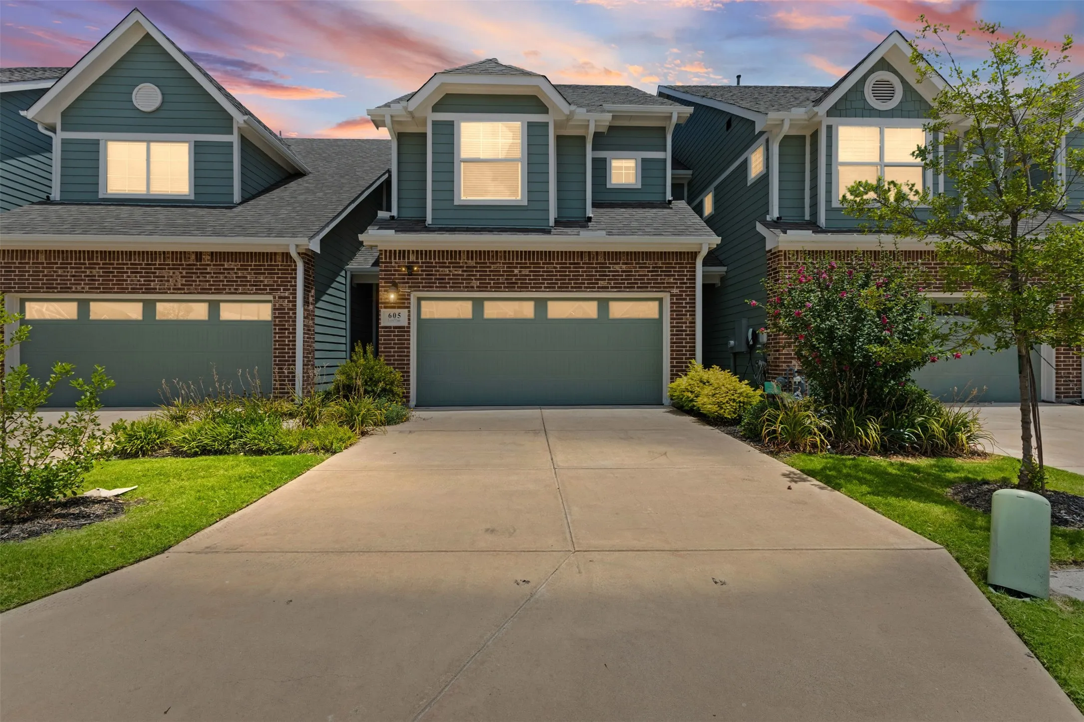 Contemporary townhome exterior featuring brick and siding finishes