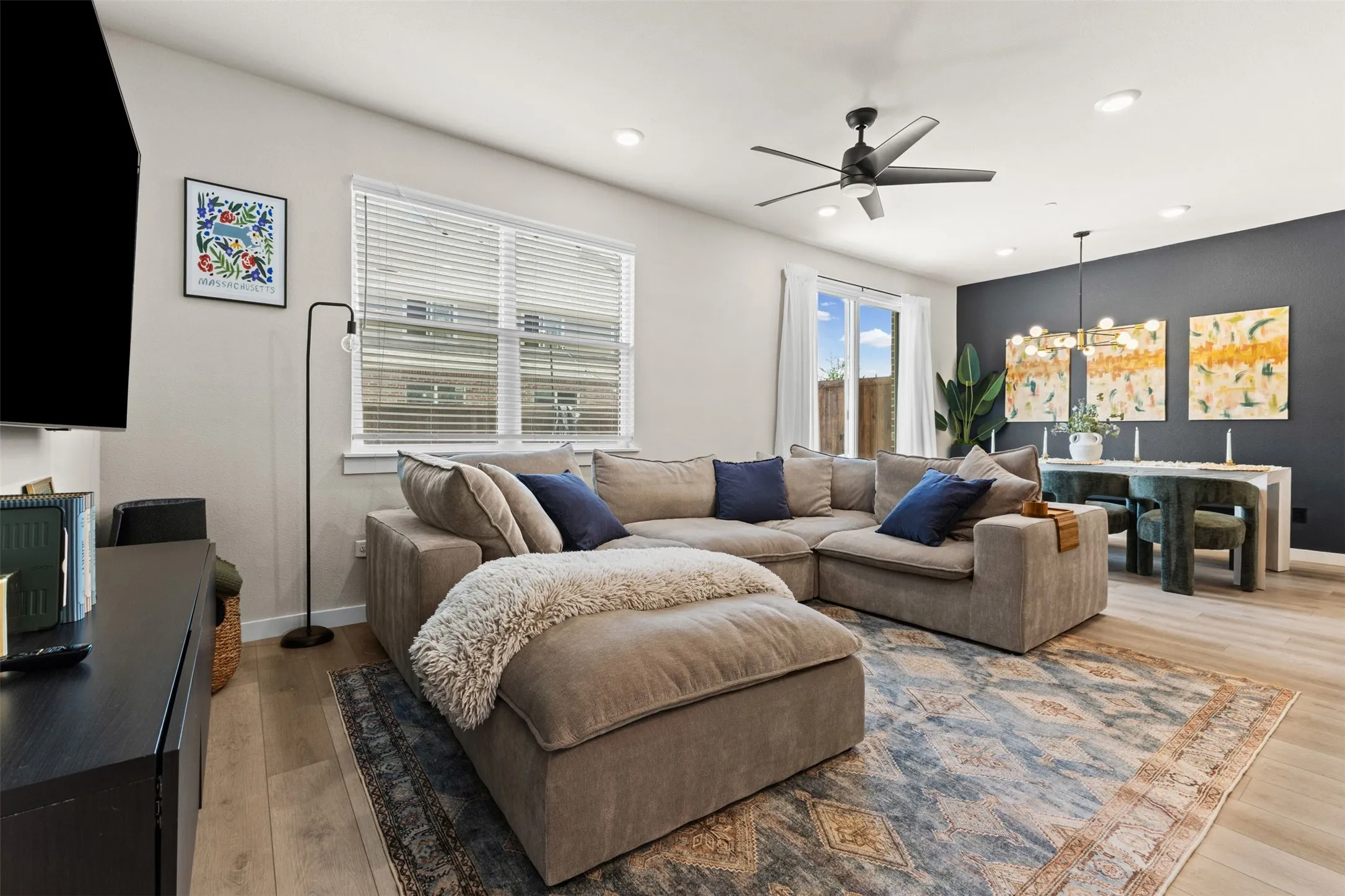 Open-concept living space featuring wood-finish flooring and recessed lighting