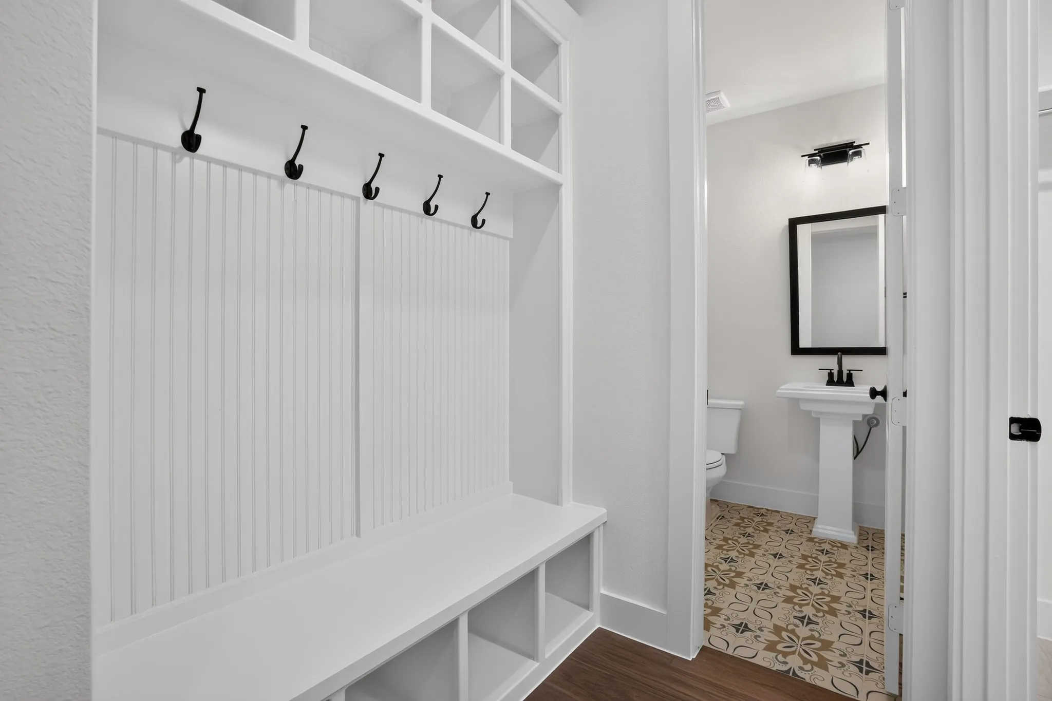 Built-in mudroom bench with cubby storage and upper shelving