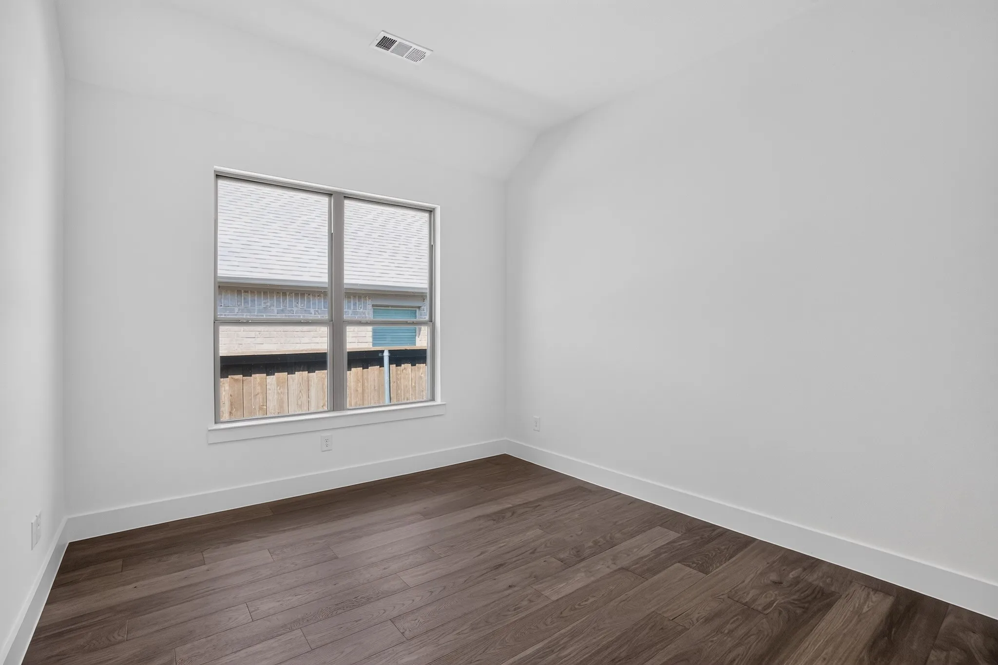 Angled ceiling featuring a recessed air vent