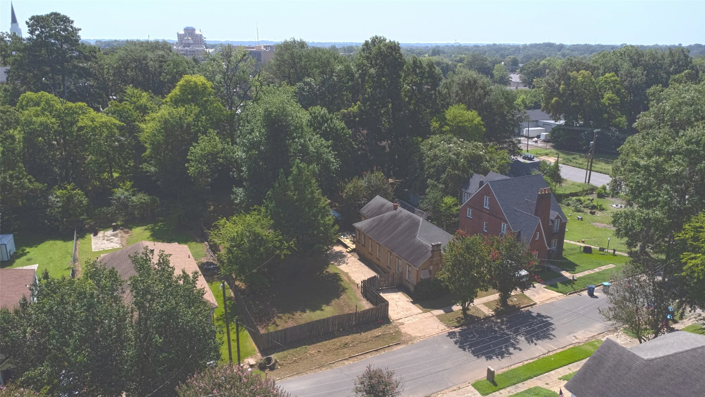 Two-story brick residence with multiple gables and a prominent chimney