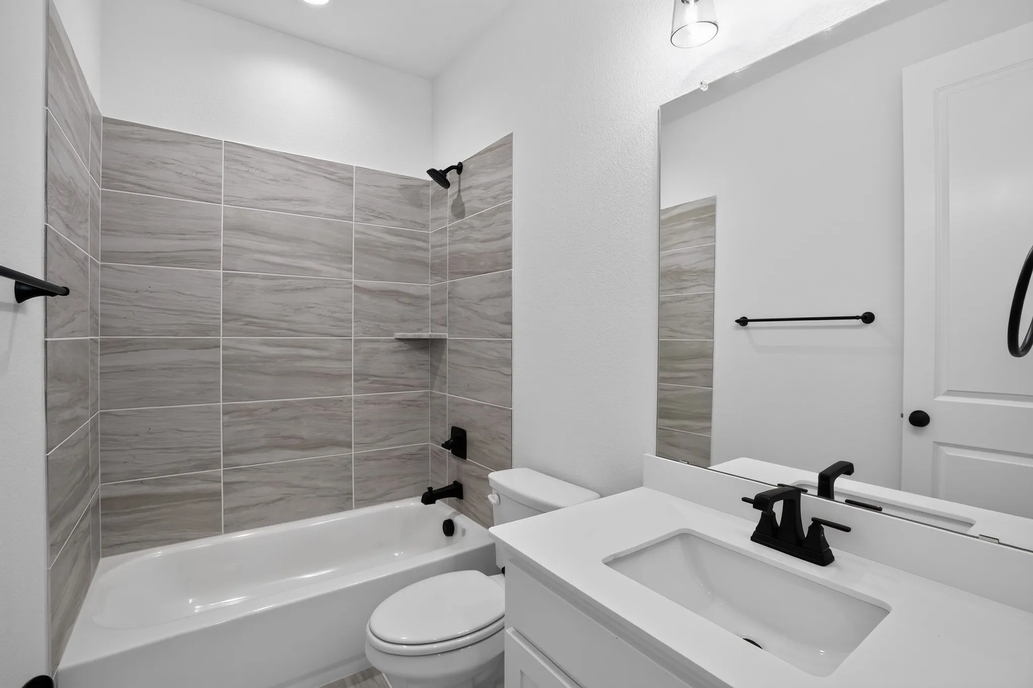 White vanity with an integrated sink and matte black faucet