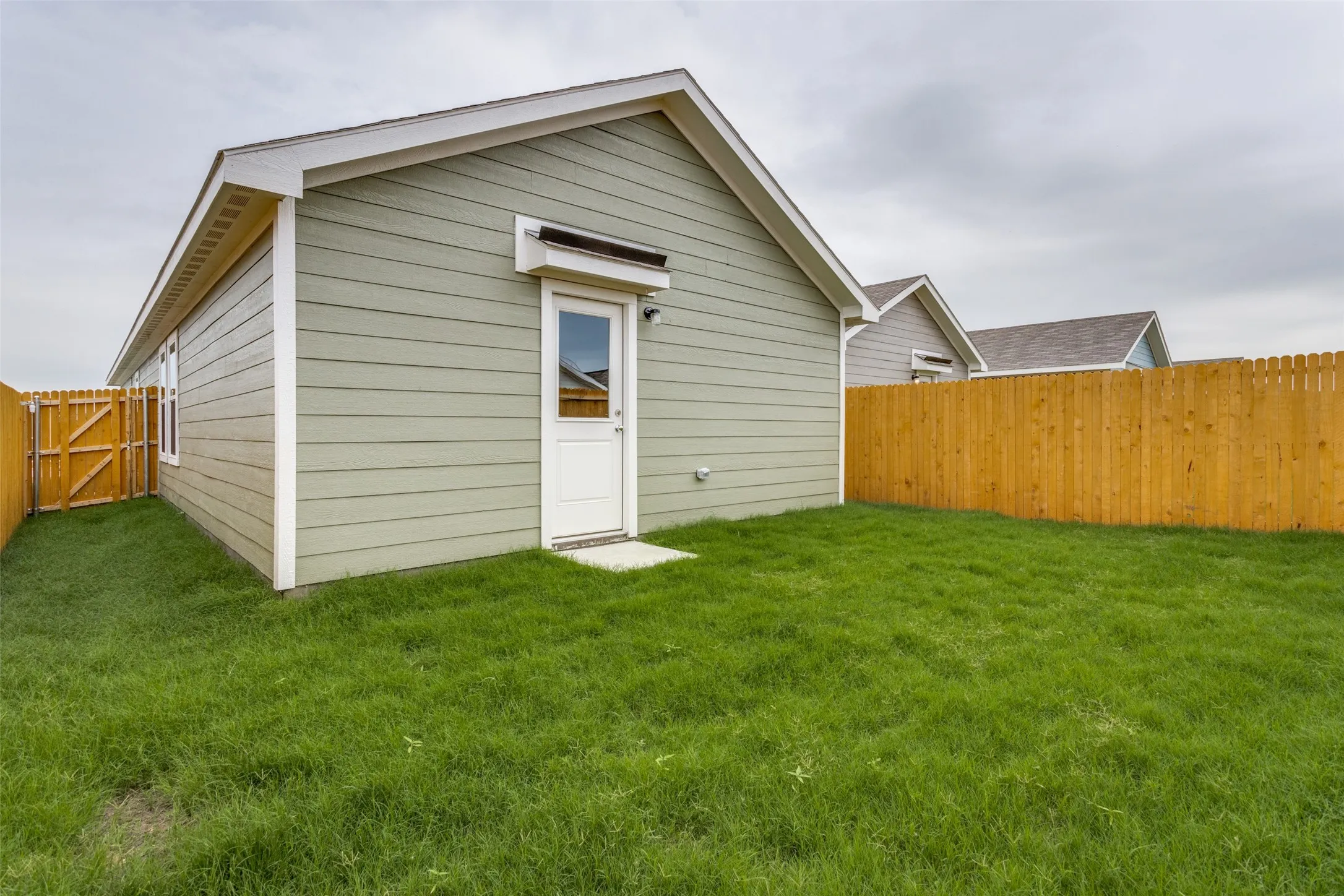 Back of house featuring a lawn