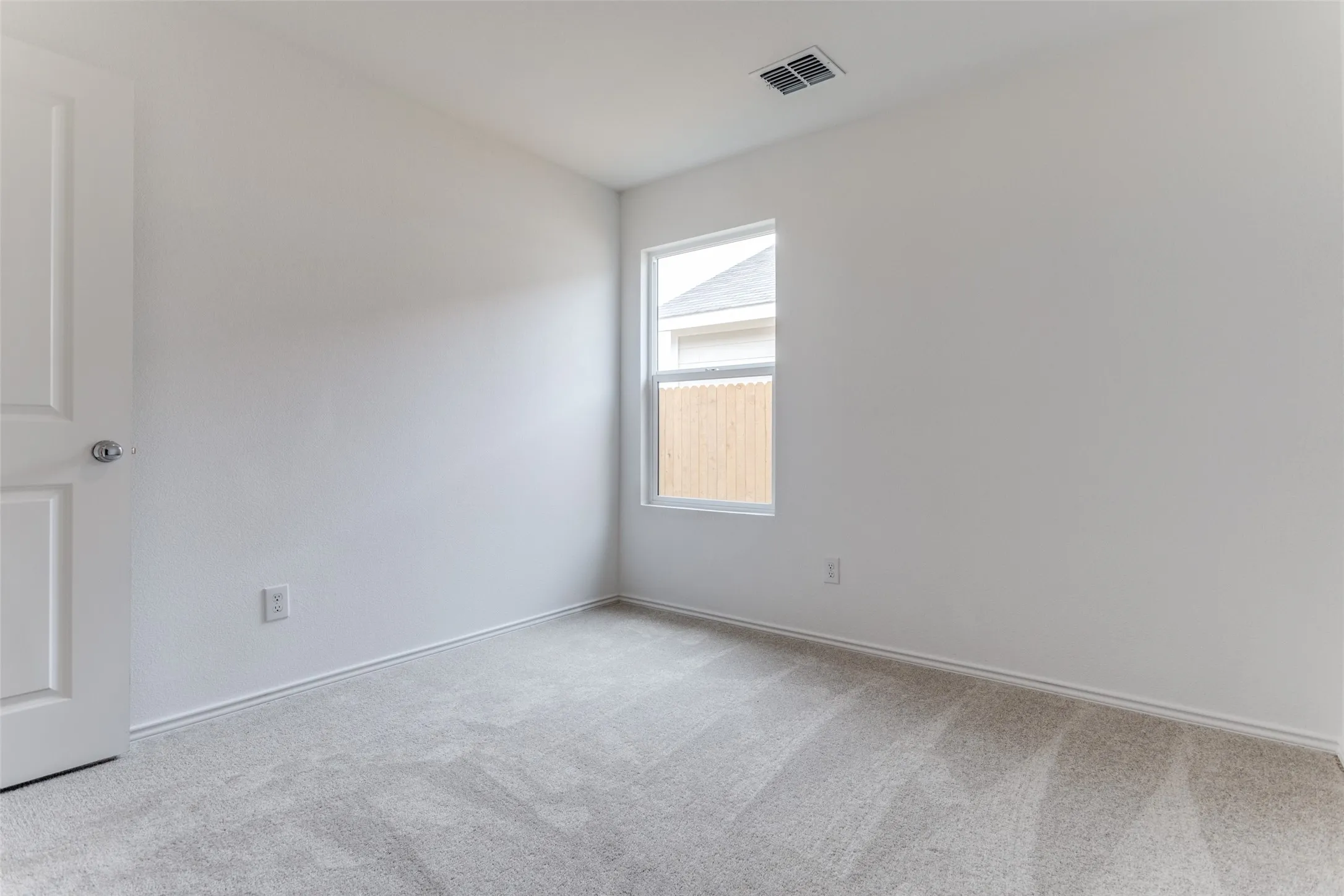 Empty room with carpet flooring