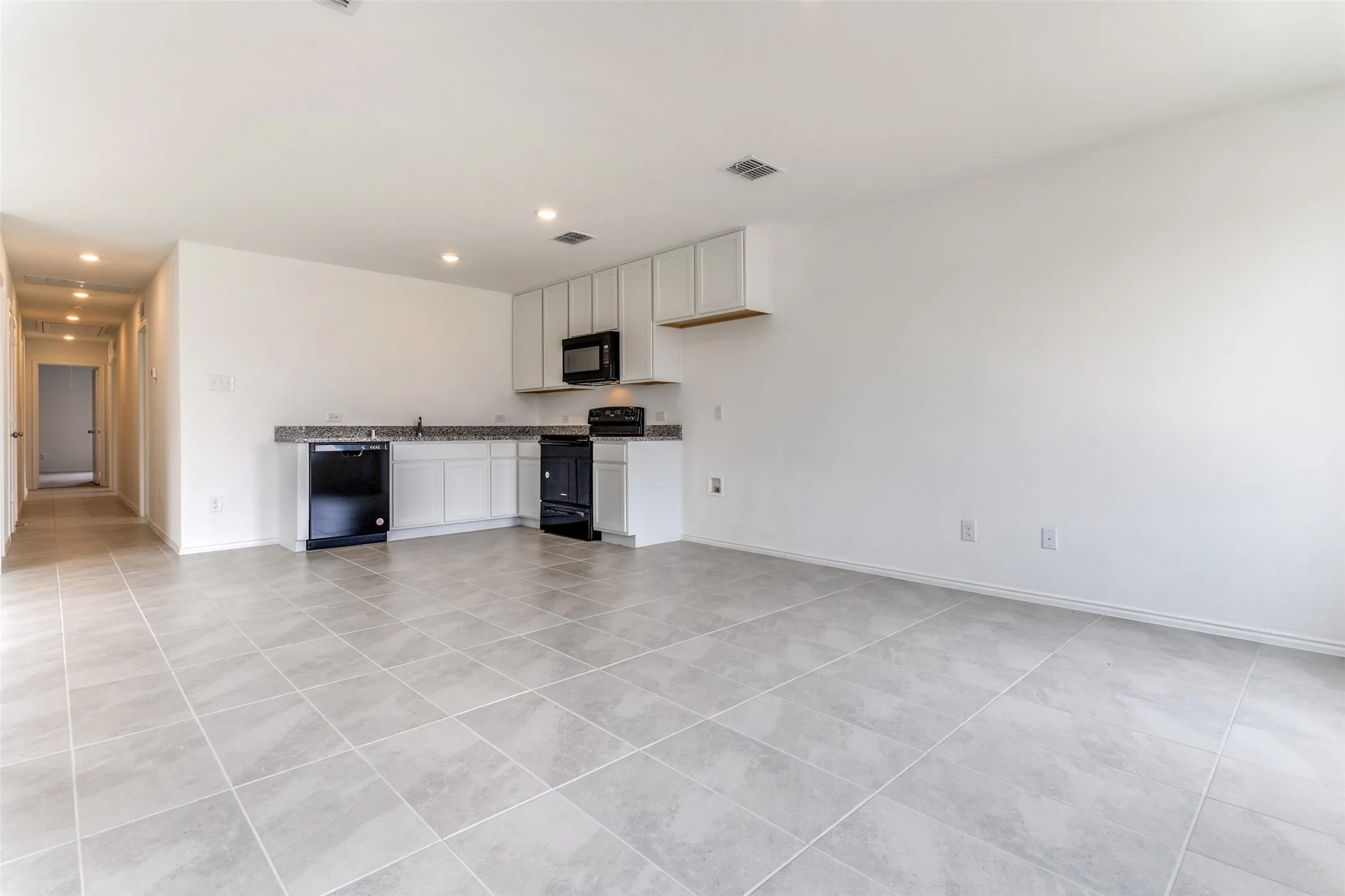 Unfurnished living room with light tile floors