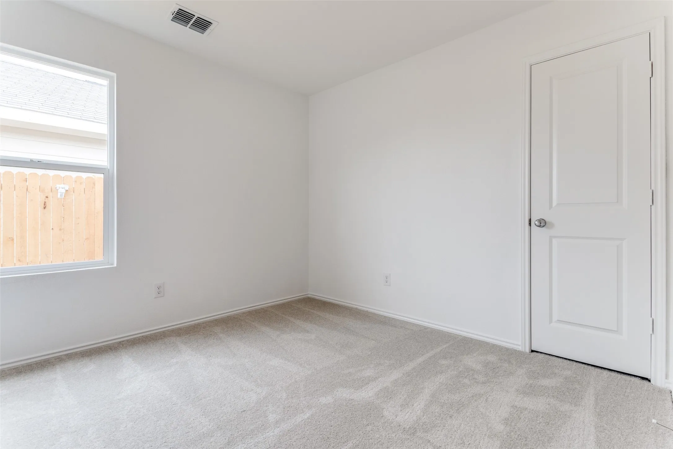 Carpeted spare room with a wealth of natural light