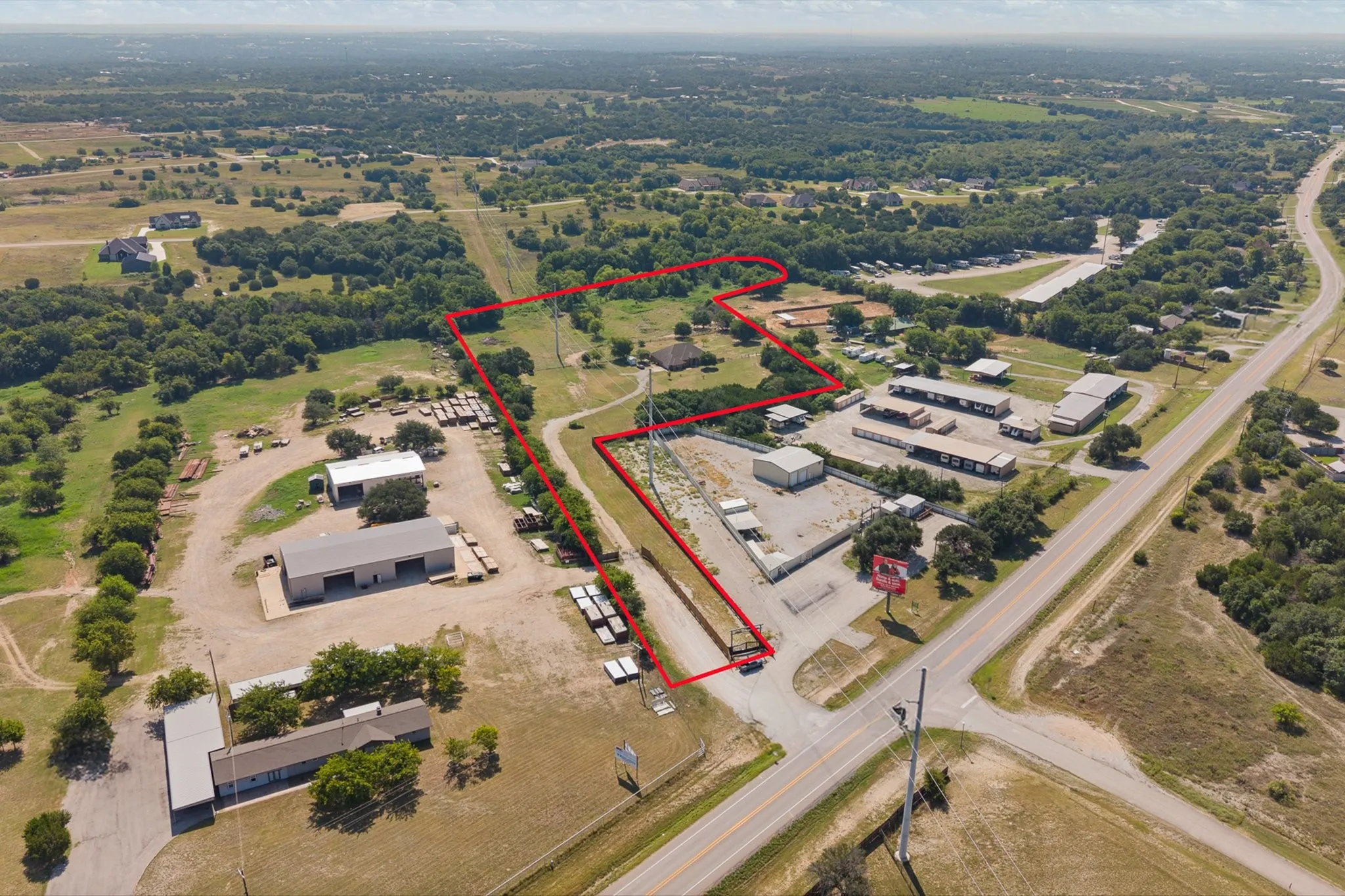 Expansive parcel featuring established structures and direct road frontage