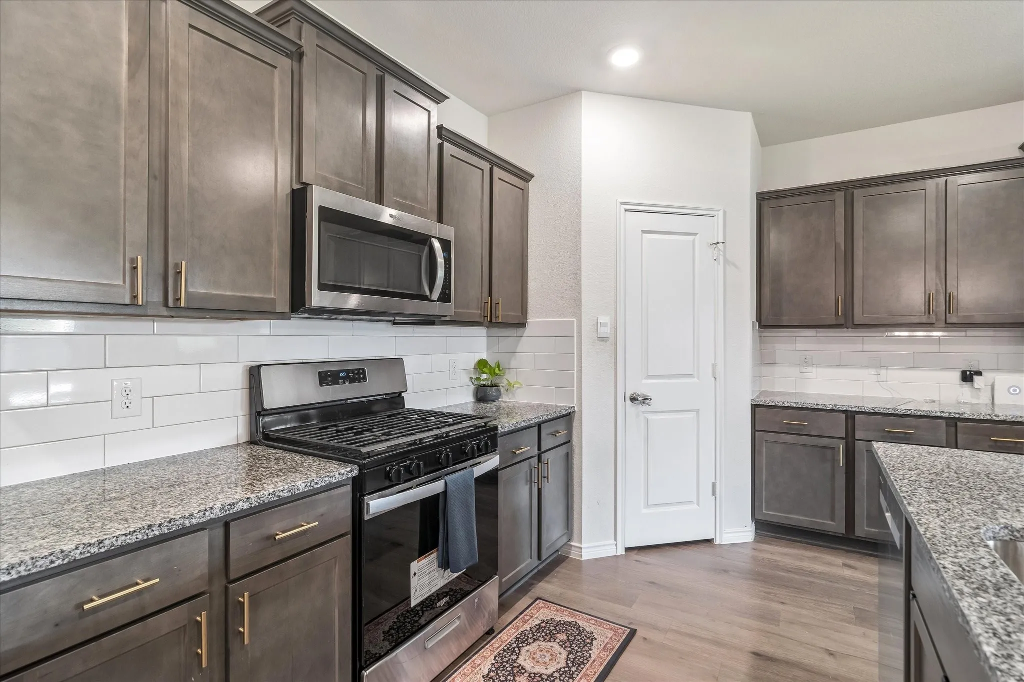 Open-concept living space featuring wood-finish flooring, recessed lighting, and a ceiling fan