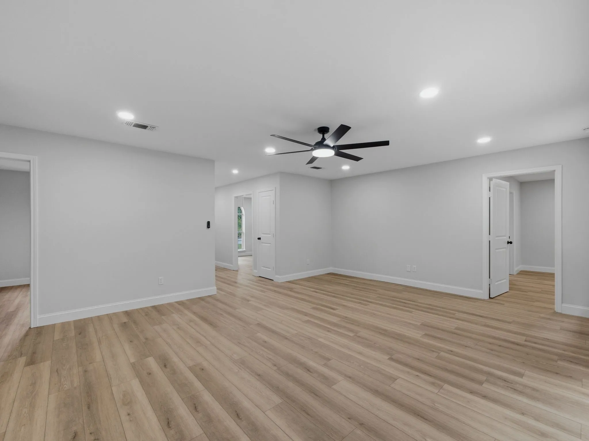 Primary living area looking toward primary entrance and kitchen area

