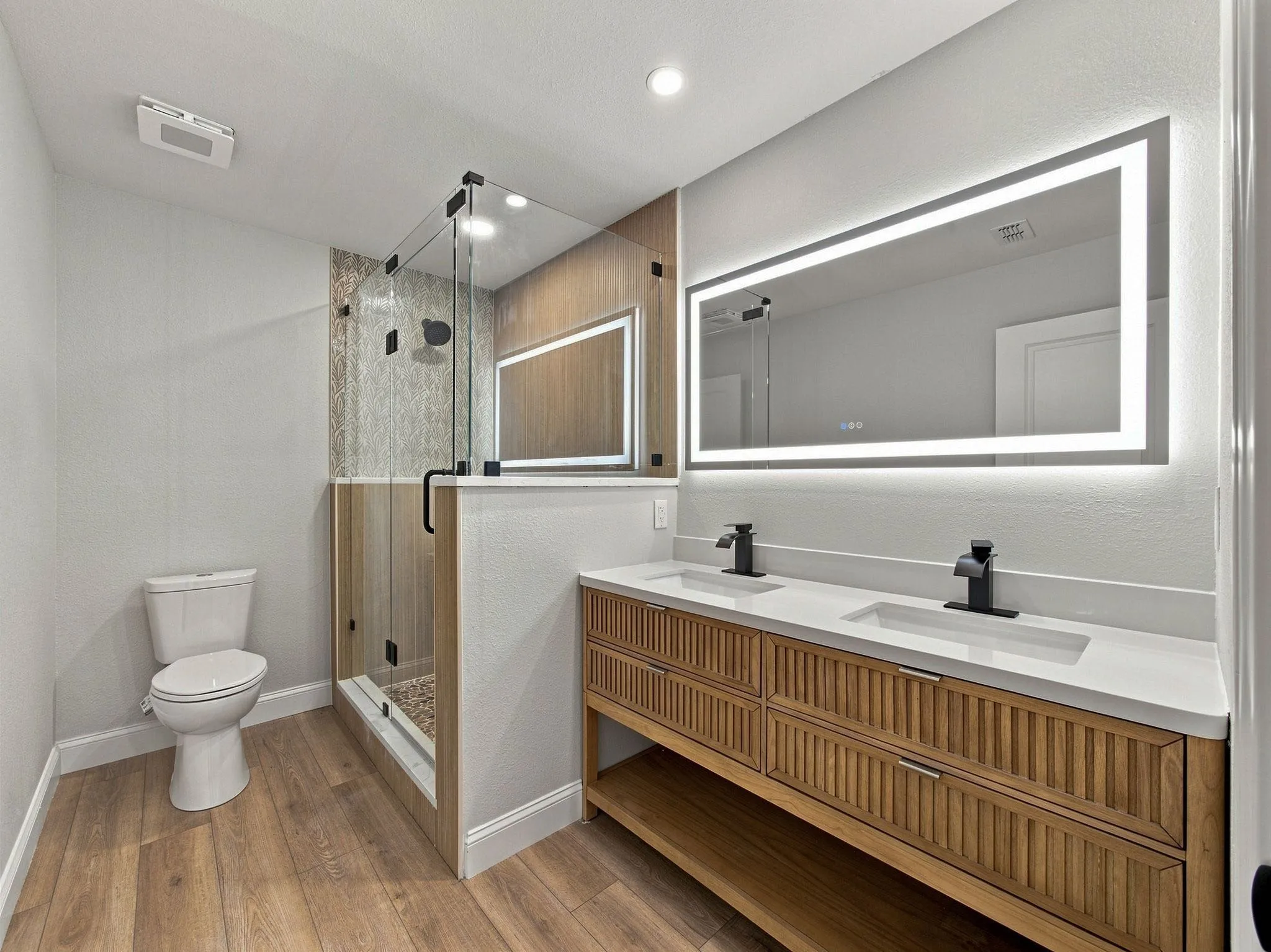 Primary Bathroom with lit mirror turned on
