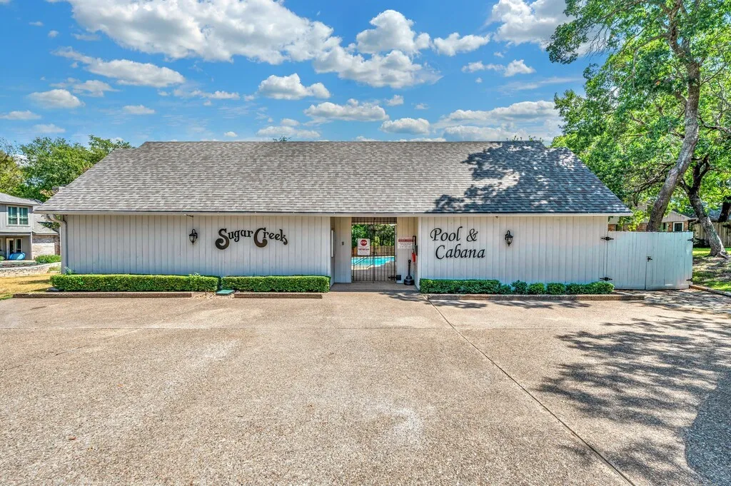 Community building with an inviting entrance to the pool and cabana area