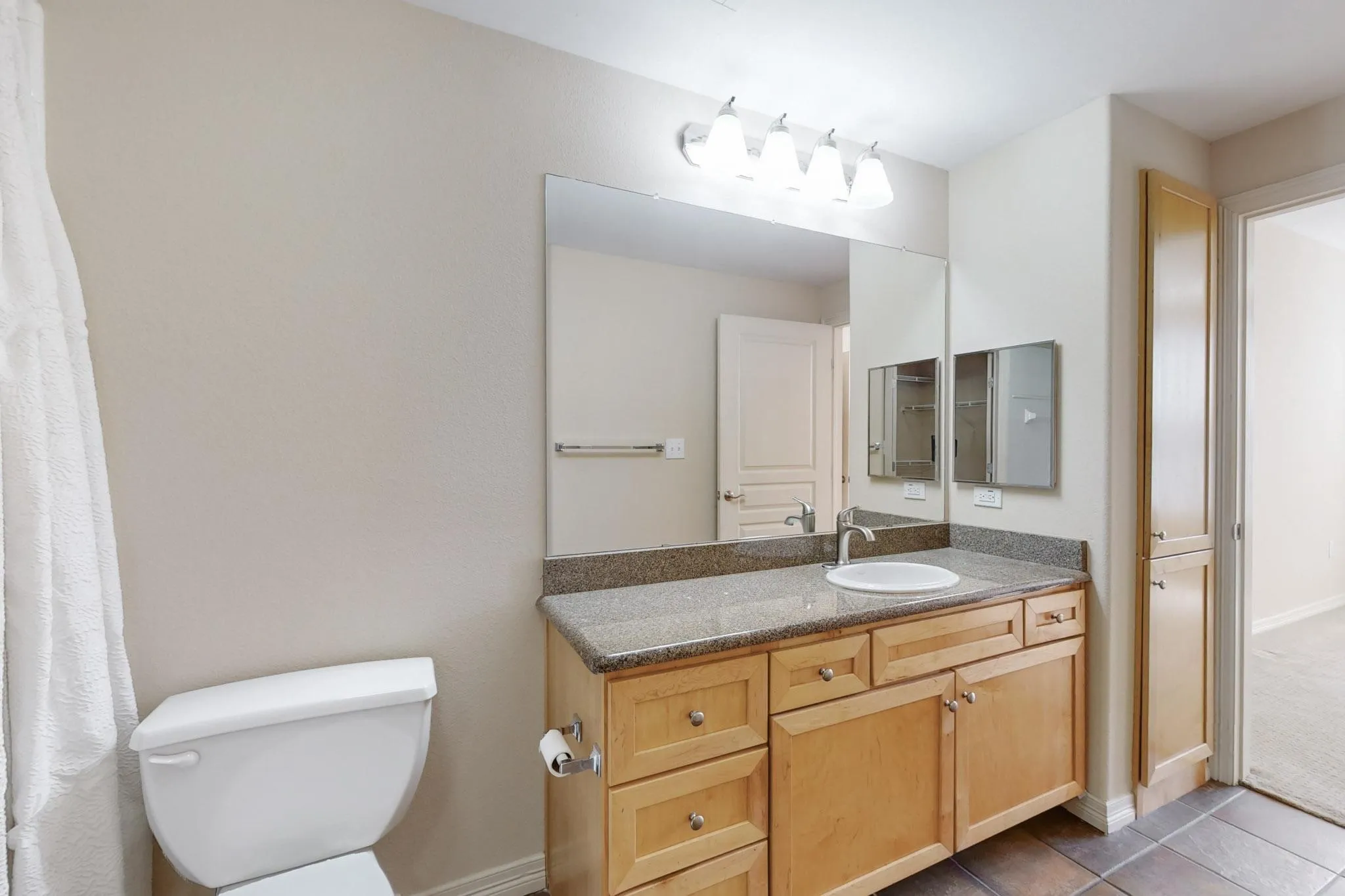 Bathroom with vanity and light tile patterned flooring